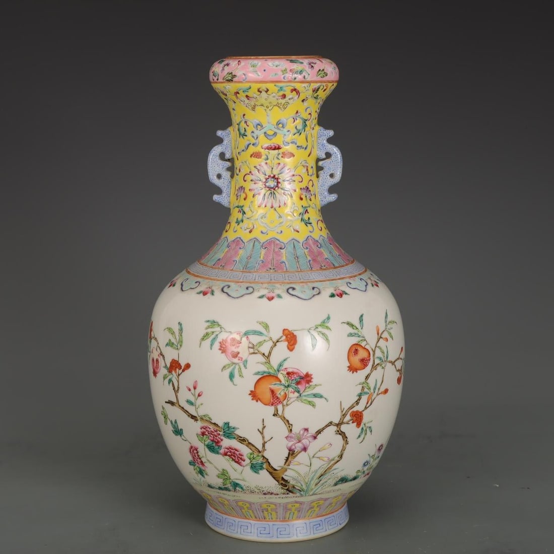 A famille rose pomegranate pattern double-handled rolled bottle made during the Daoguang era of the: A famille rose pomegranate pattern double-handled rolled bottle made during the Daoguangnian era of the Qing Dynasty Size:H:28.5cm Belly diameter:16cm (The Dimensions Of All Batches Are Manually Measu