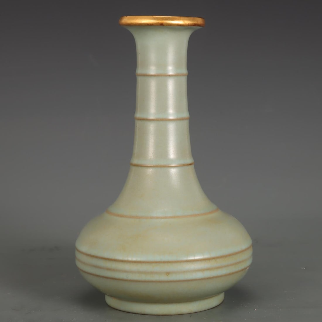 A Song Dynasty Ru kiln vase with sky-blue glaze and gilded buckle string pattern: A sky-blue glazed bottle with gold-inlaid buckle string pattern from the Song Dynasty Ru kiln Size:H:22.6cm Belly diameter:14.8cm (The Dimensions Of All Batches Are Manually Measured.If You Need More 
