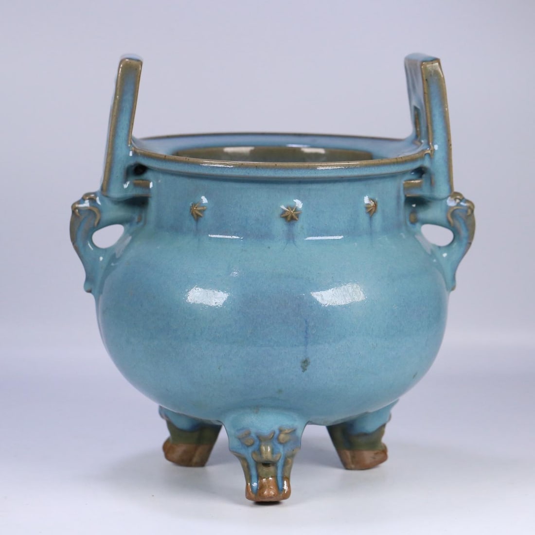 One is a Song Dynasty Jun kiln sky-blue glazed three-legged double-handled burner: A sky-blue glazed three-legged double-handled burner from the Song dynasty Jun kiln Size:27x25x23 cm (The Dimensions Of All Batches Are Manually Measured.If You Need More Detailed Information, Please 