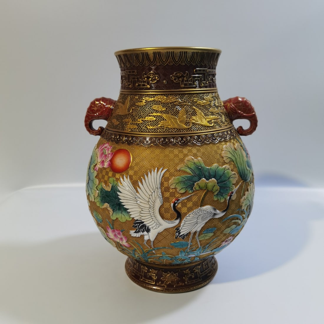 A Qing Dynasty Qianlong period carved gilded crane, mandarin duck, lotus, and elephant trunk zun: A gilded carved crane, mandarin, mandarin, lotus, and elephant trunk zun made during the Qianlong period of the Qing Dynasty Size:29x13x13cm (The Dimensions Of All Batches Are Manually Measured.If You