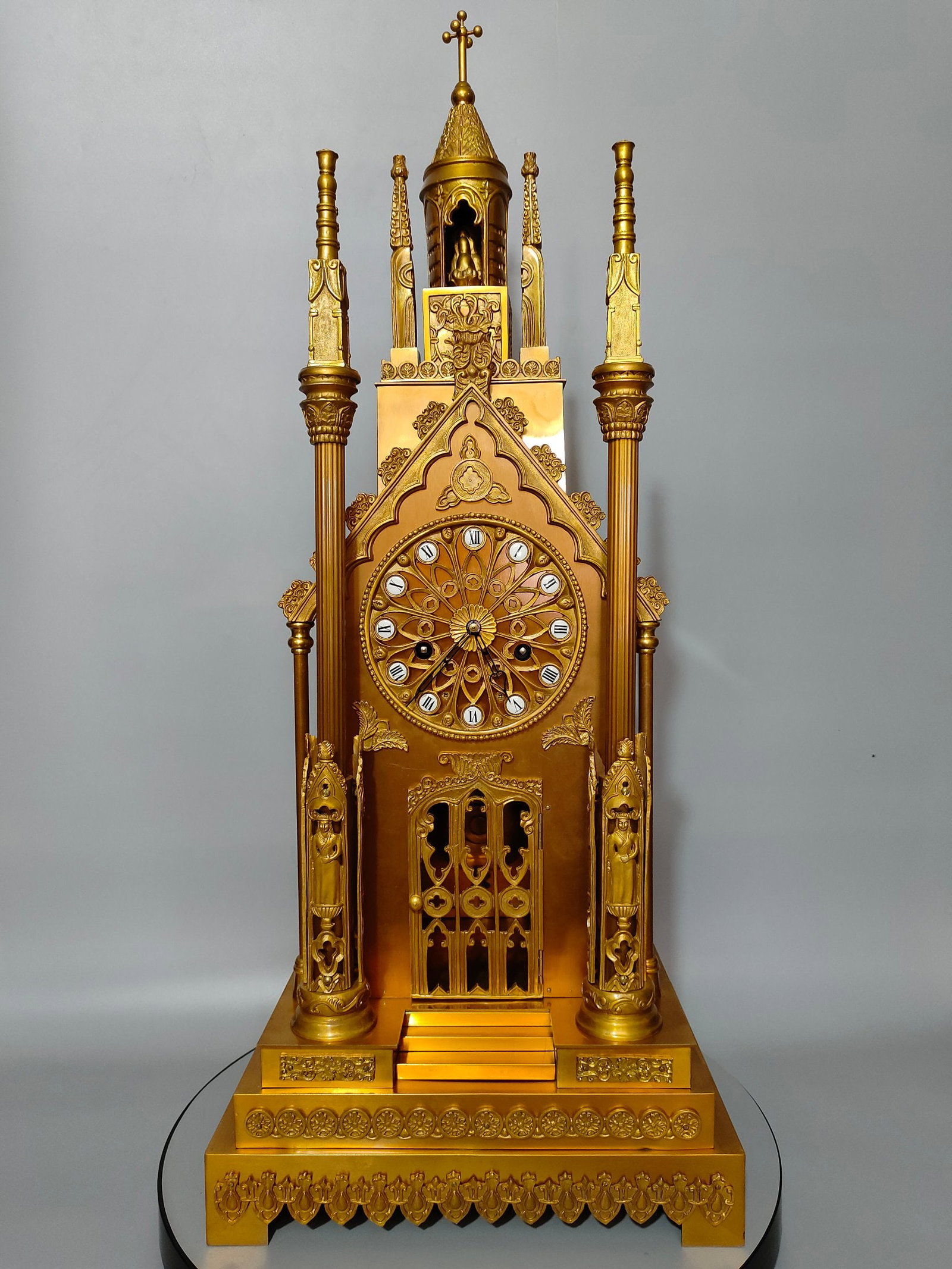 A finely crafted gilded bronze church bell with a finely carved column