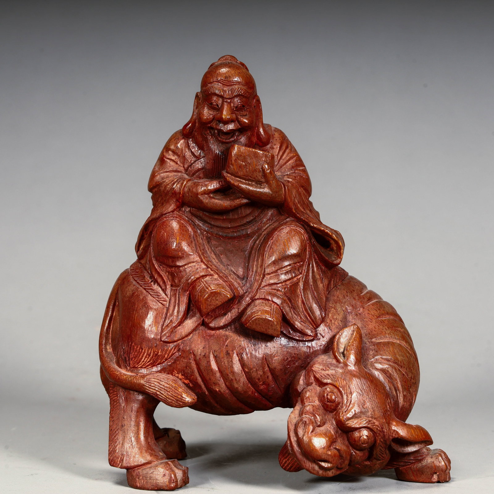 A Qing Dynasty bamboo carving figurine depicting a tiger-riding figure (1 of 9)
