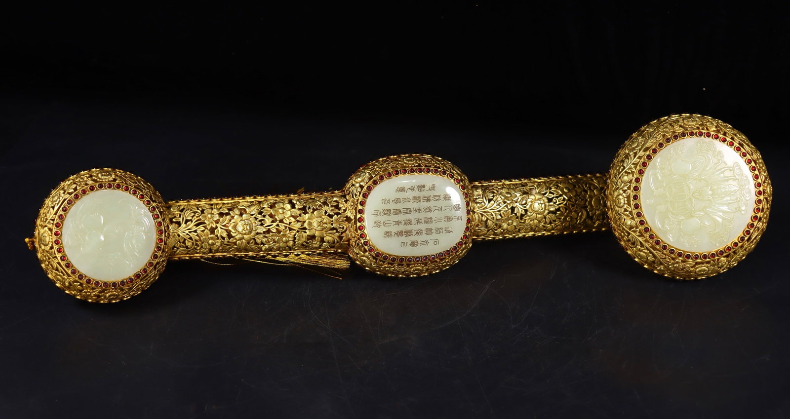 A Qing Dynasty copper gilded Hetian jade Ruyi: A Qing dynasty copper gilt inlaid Hetian jade ruyi scepter Size:H:9.5cm L:47cm W:11cm W:1.05kg (The Dimensions Of All Batches Are Manually Measured.If You Need More Detailed Information, Please Contac