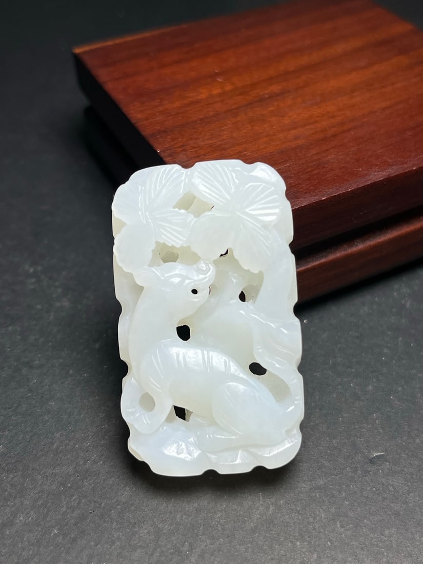 A delicate Hetian jade pendant: 'Tiger Roars in the Mountains, Deer Enters the Mountains, Cranes (1 of 7)
