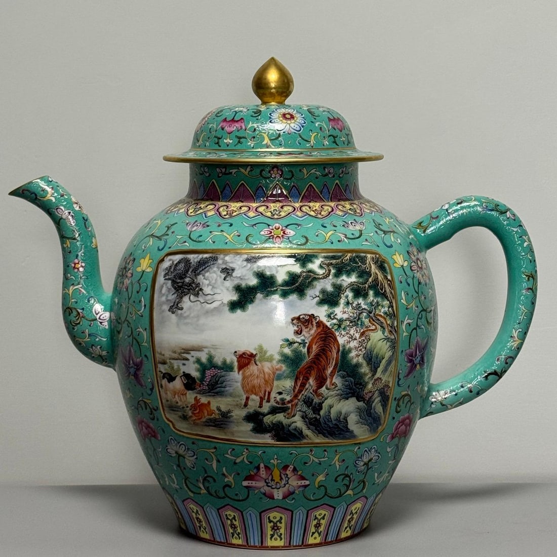 A large Qing dynasty tea pot featuring a famille rose green ground with a Dao-patterned fortune and: A Qing Dynasty famille rose green ground tea pot with a continuous consecration of the twelve zodiac animals featuring a pattern of fortune and longevity Size: H: 52cm L: 58cm W: 33.5cm (The Dimension