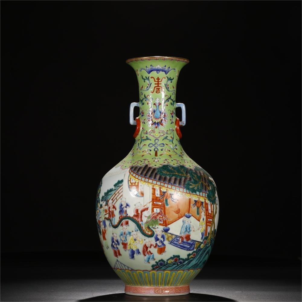 A Qing Dynasty Qianlong period green famille rose infant playing scene double-handled ringed vase: A green-ground, famille-rose double-handled ringed vase with infant play scene, made during the Qianlong period of the Qing Dynasty Size:H:43.3cm Calibre:11.8cm Bottom:12cm (The Dimensions Of All Batc