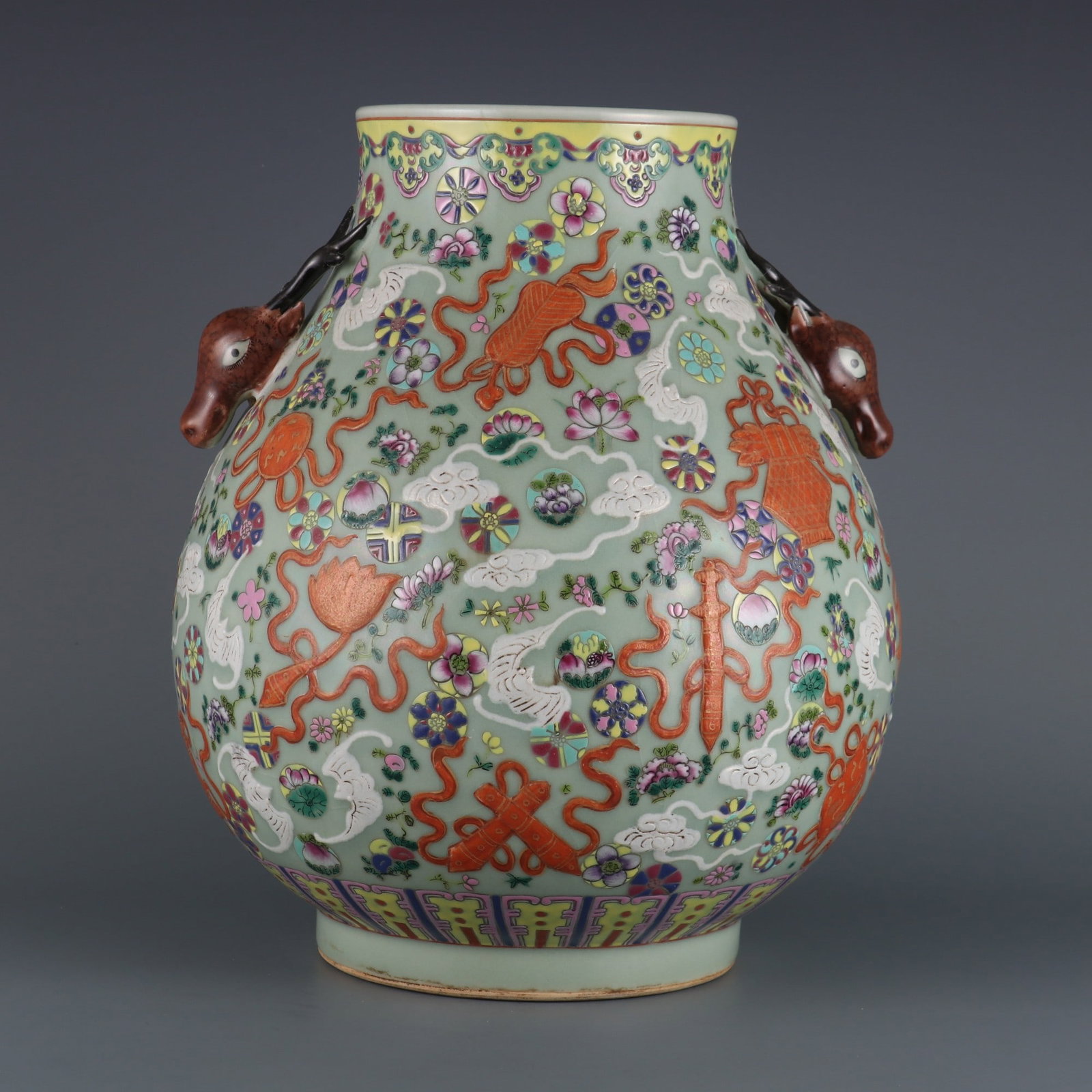 A Qing dynasty Qianlong period carved and gilded famille rose famille rose with a leather ball and: A bean-green glaze carved, gold-painted famille rose with eight treasures pattern, leather ball with a floral deer head made during the Qianlong period of the Qing Dynasty Size:H:33.5cm Calibre:14.5cm