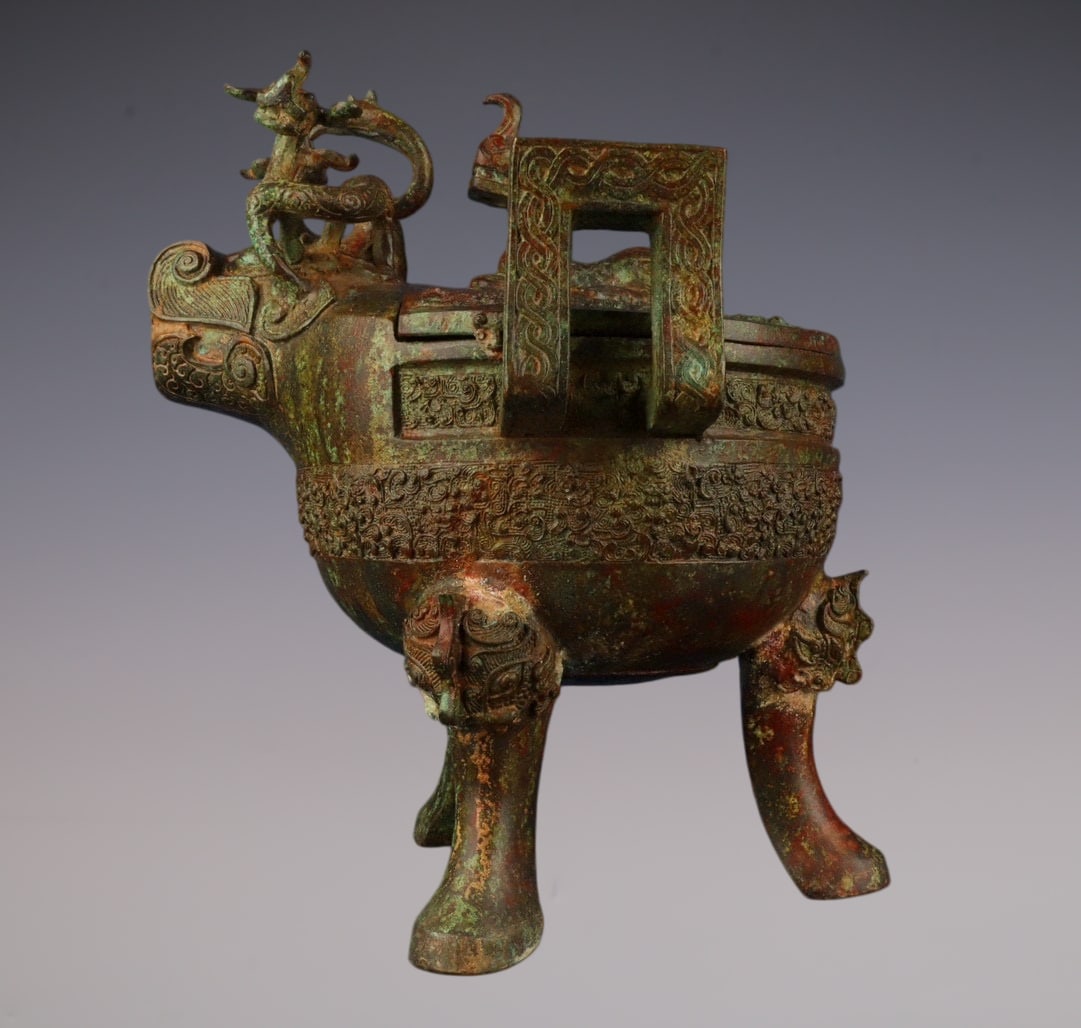 An Archaic Bronze Beast-head Double-Ears and Tripod Cup,With Inscription: An Archaic Bronze Beast-head Double-Ears and Tripod Cup,With Inscription,W.Zhou ,China,Size:31cmx31cm,Weight:6050g (The Dimensions Of All Batches Are Manually Measured.If You Need More Detailed Inform