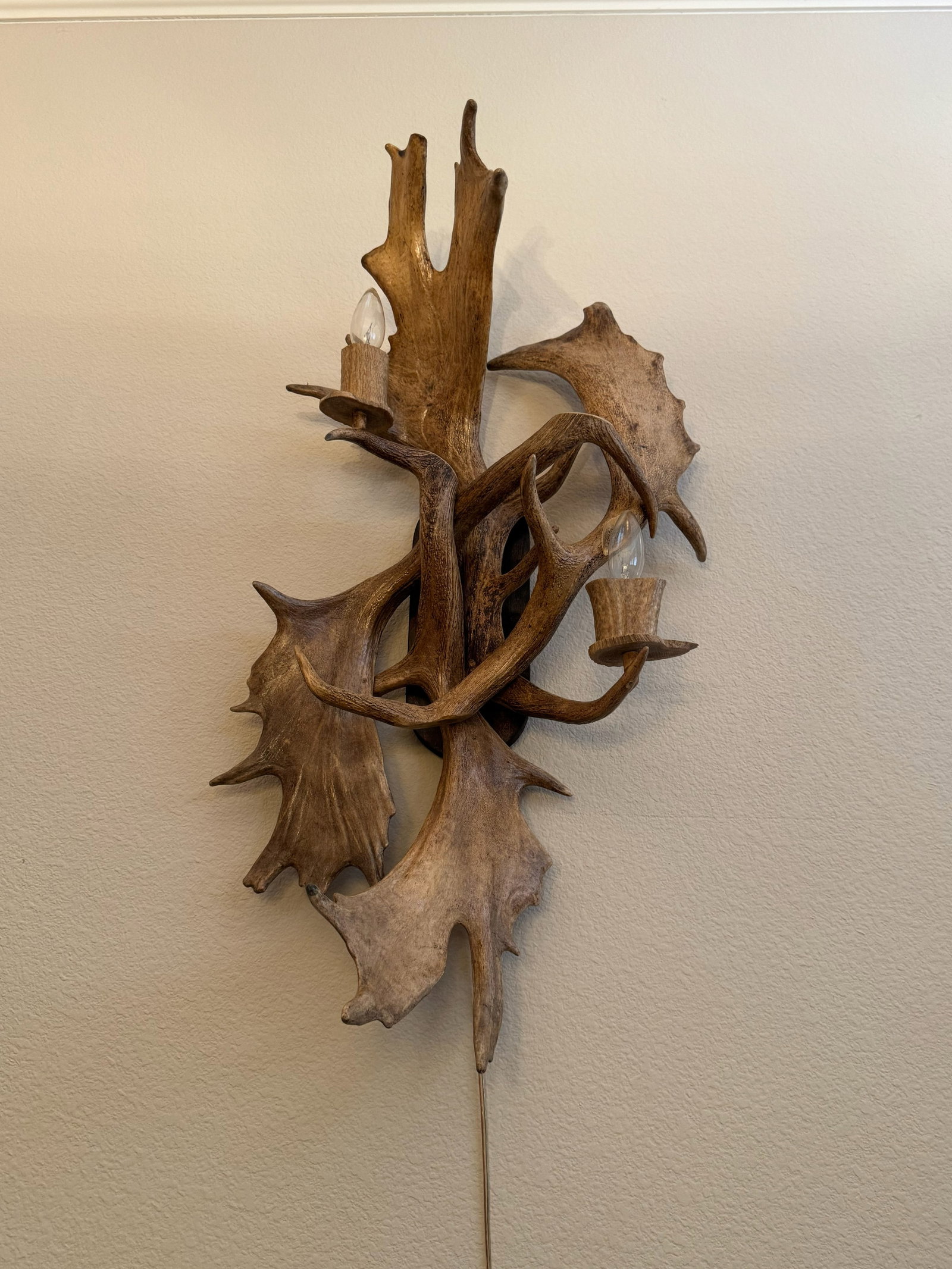 Grand Moose & Deer Antler 2-Light Wall Mount: Make a bold Northwoods statement with this dramatic 2-light antler wall sconce! Crafted using broad, palmate moose antler paddles interwoven with shed deer antlers, this substantial fixture includes t
