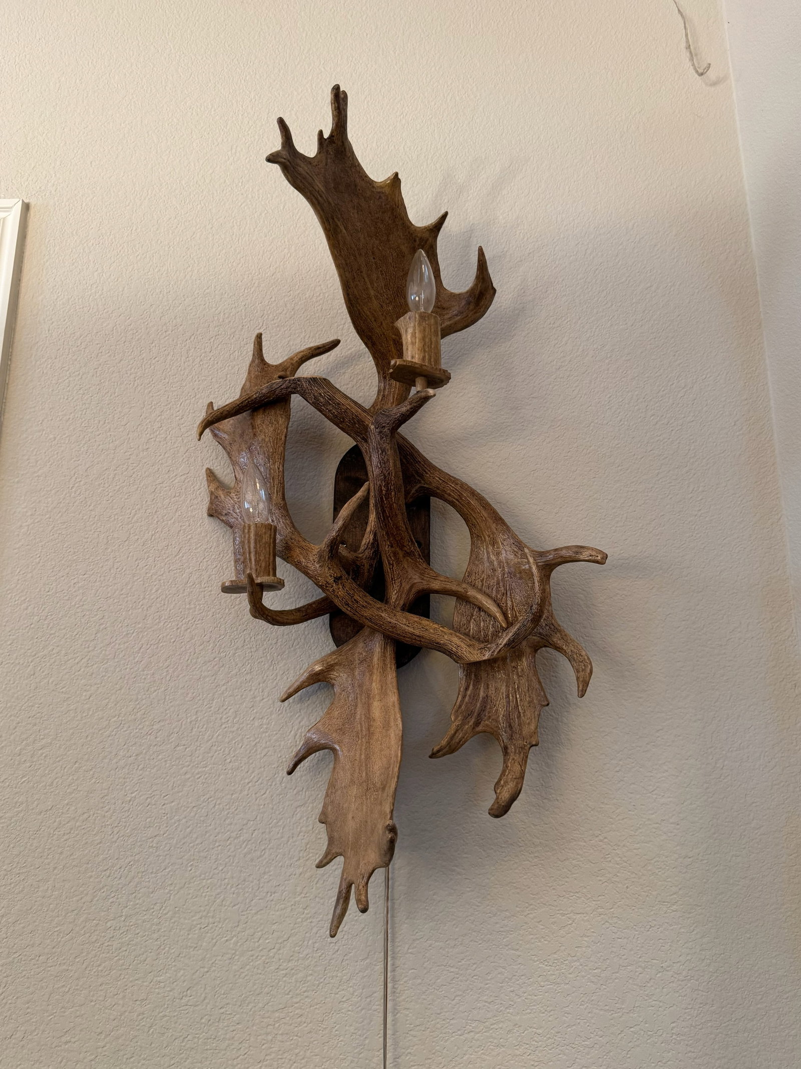Grand Moose & Deer Antler 2-Light Wall Mount: The perfect matching pair to Lot #18! This grand rustic wall sconce features moose paddle antlers paired with deer tines in an expressive, multi-layered arrangement. Complete with two candle-style soc
