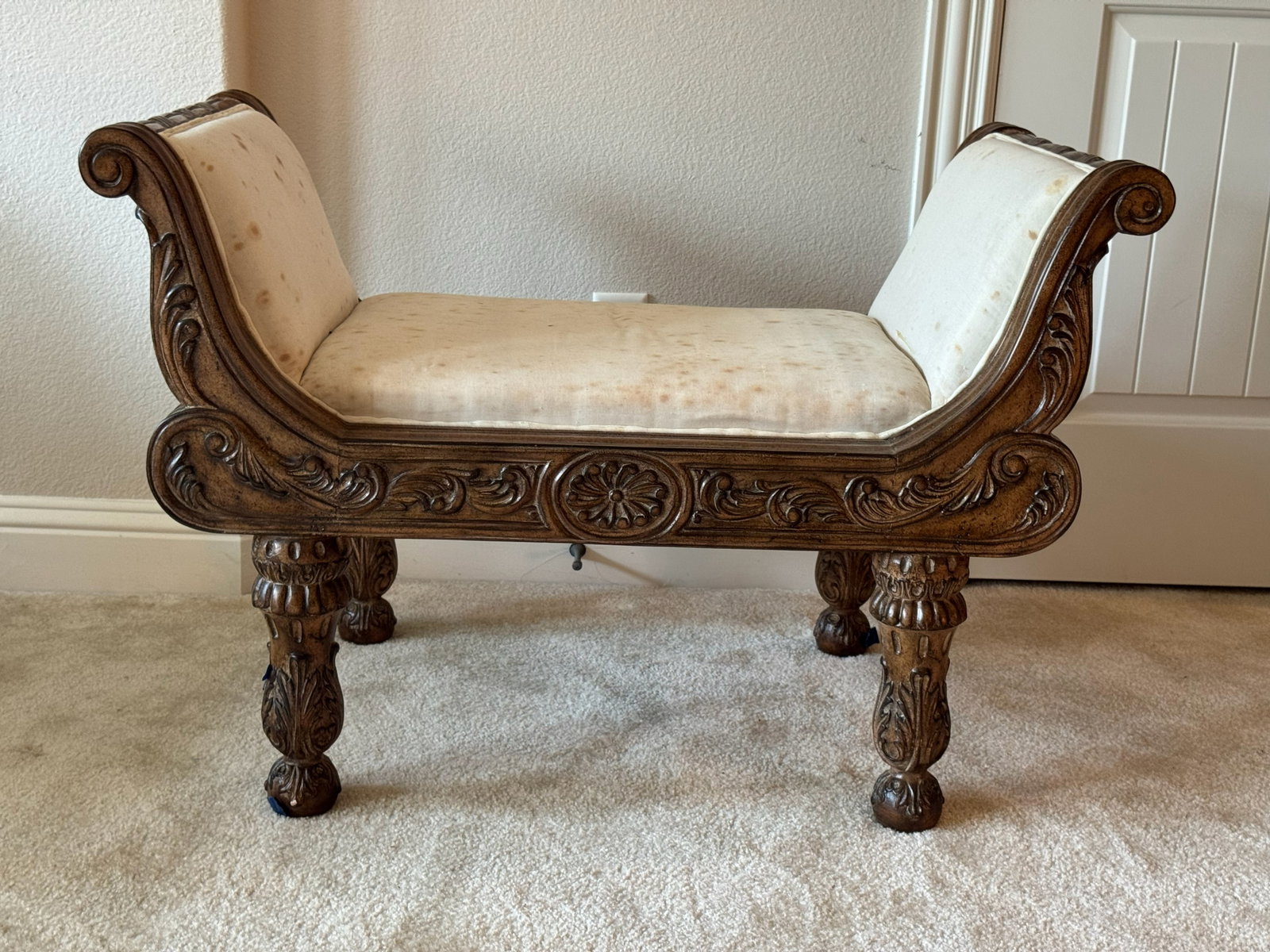 Elegant Carved Dark Wood Accent Window Bench: The matching companion piece to Lot #29! Designed with gracefully curved side arms, intricate hand-carved floral motifs along the apron, and sturdy turned legs. Upholstered in the same tailored