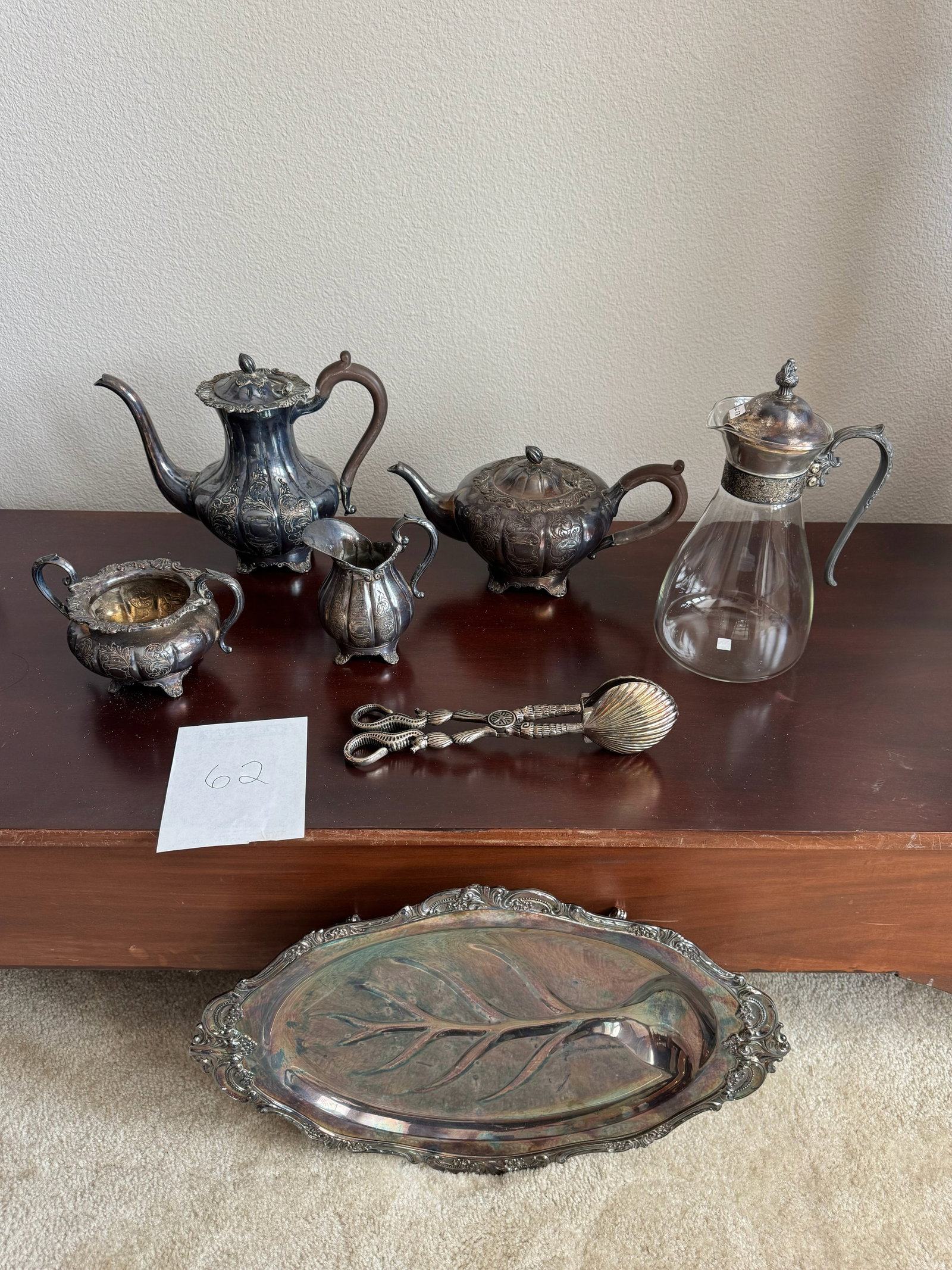 An eclectic vintage six-piece silver-plated: Collection of six vintage silver-plated serving and tea service pieces in assorted forms and patterns. Pieces exhibit varying decorative details and finishes.