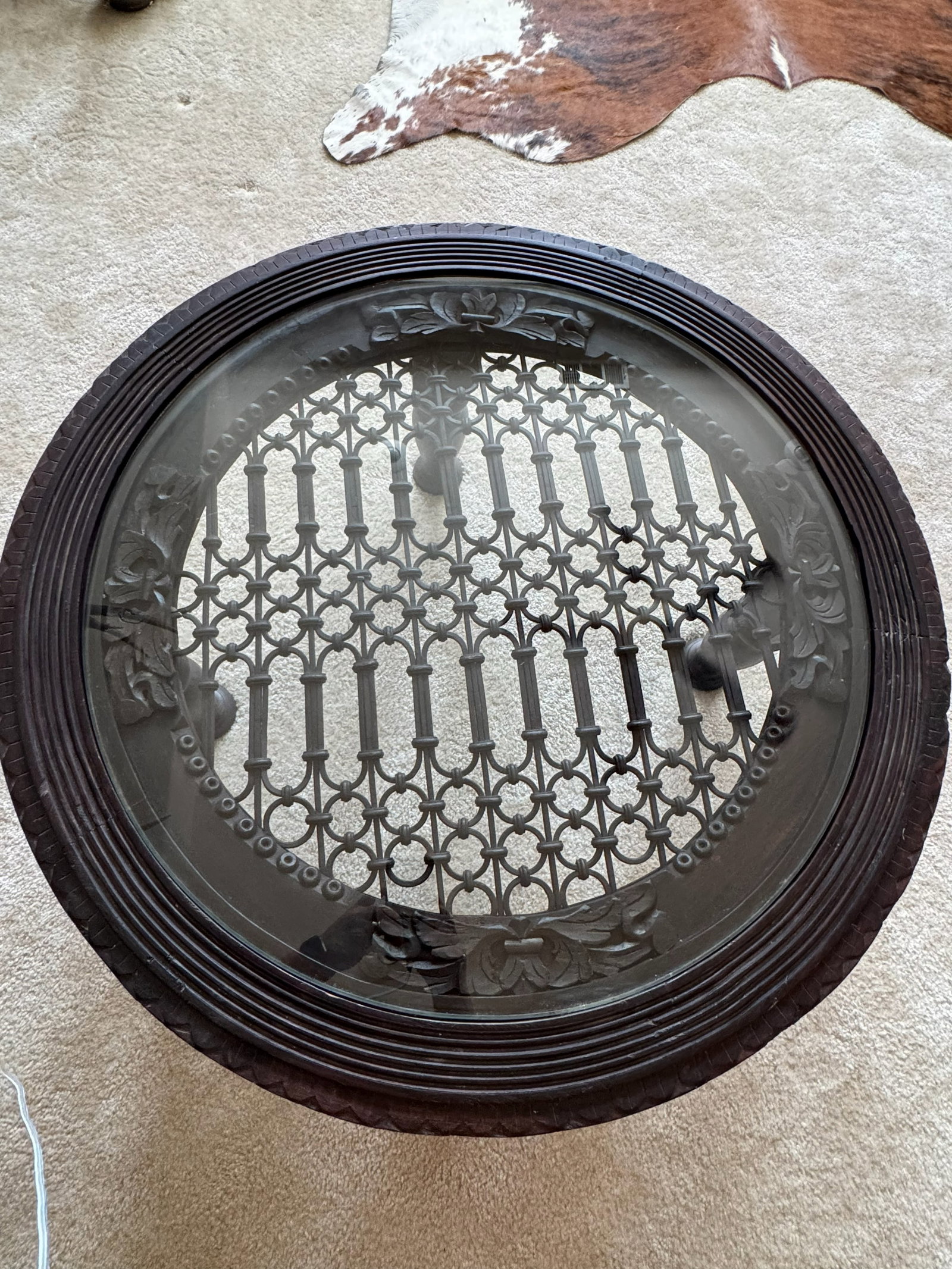 Vintage wrought iron grill Round Coffee Table: Vintage wrought iron round coffee table featuring an open grillwork design with a sturdy metal frame and decorative detailing. A versatile accent piece suitable for a variety of interior or covered