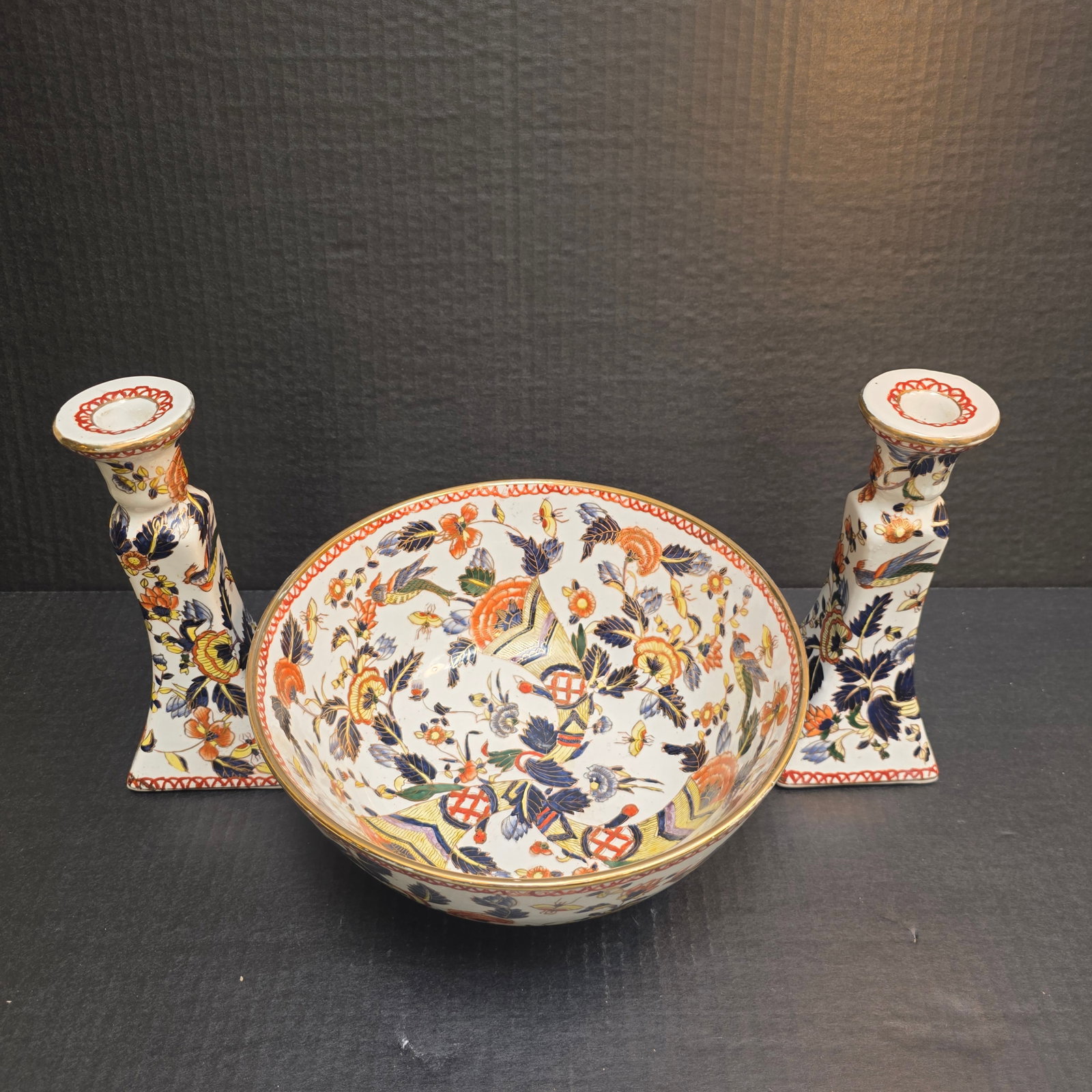 Imari Floral Antique Ironstone Bown and set of Matching Candlesticks: Striking Ironstone with cream base, navy and orange floral motif with yellow accents. Bowl measures 10 x 5" and the candlesticks 8" tall