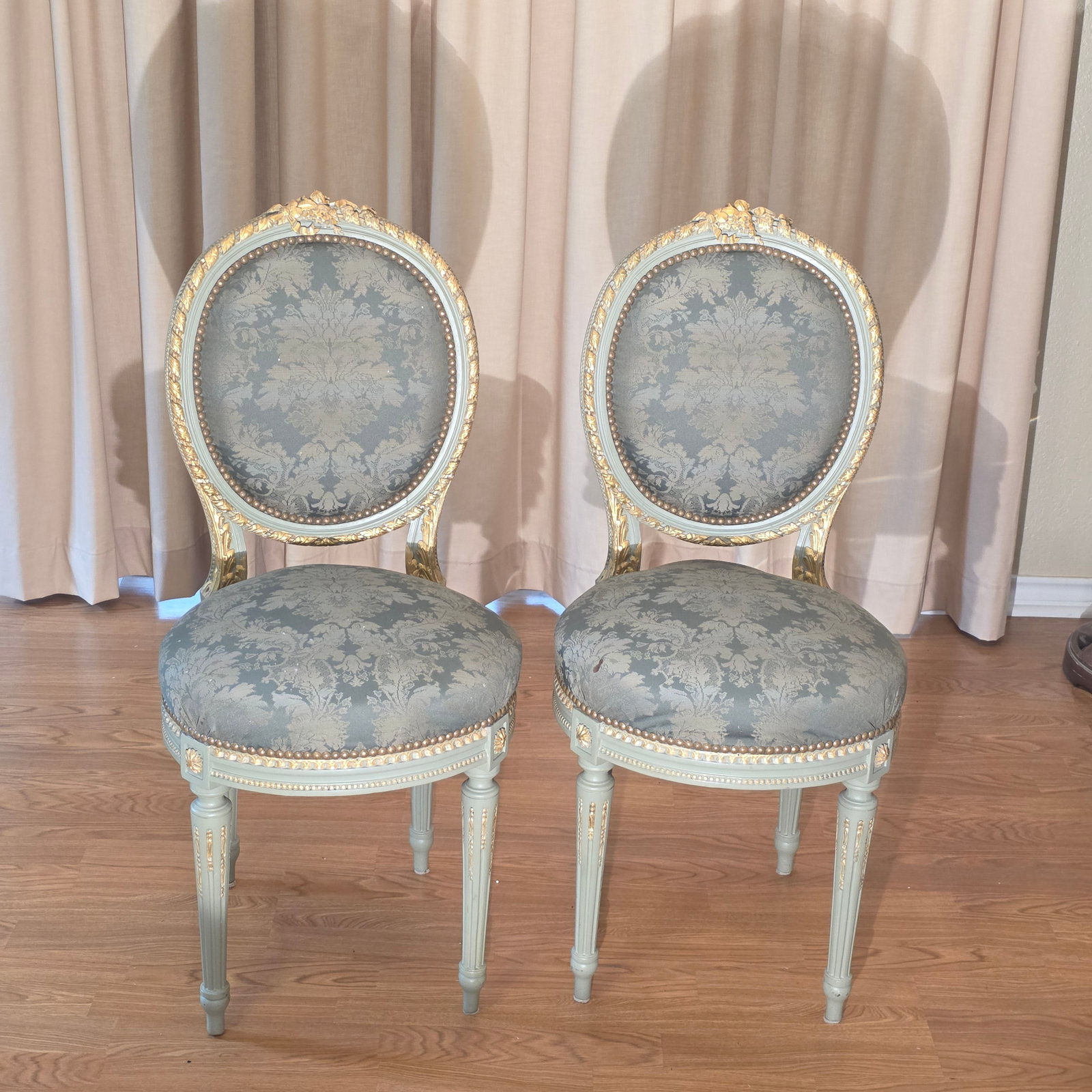 Pair of Green/Gray Colored Louis XVI Style Medallion Back Dining Chairs: These lovely chairs feature blue damask upholstery and carved green/gray giltwood frames