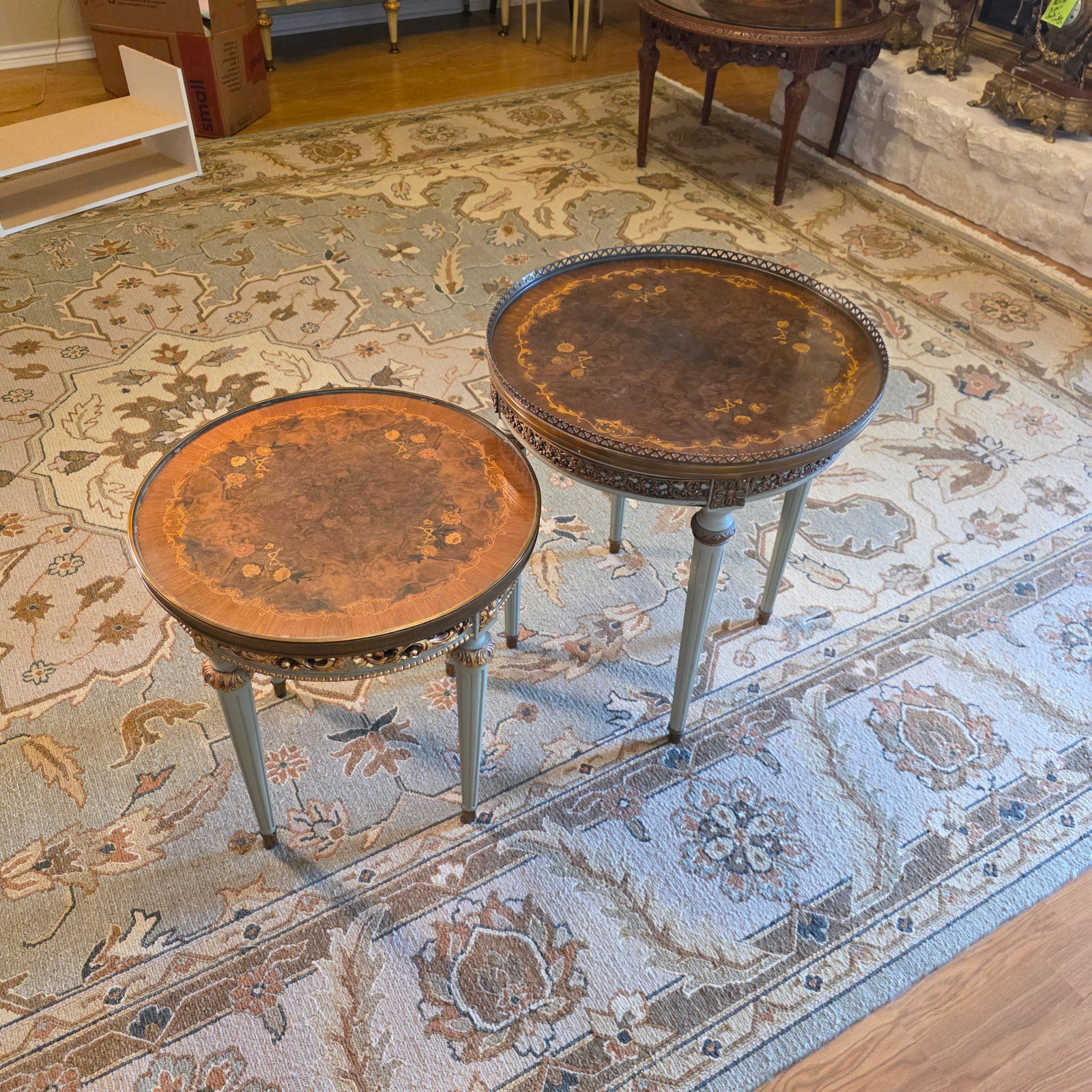 Two French Directoire Mahogany Boulliotte Tables in Gray/Green And Gilt: Made from high-quality mahogany. With brass details, marquetry tops and protective glass, these tables are a luxurious and sophisticated addition to any home. With their timeless design and quality