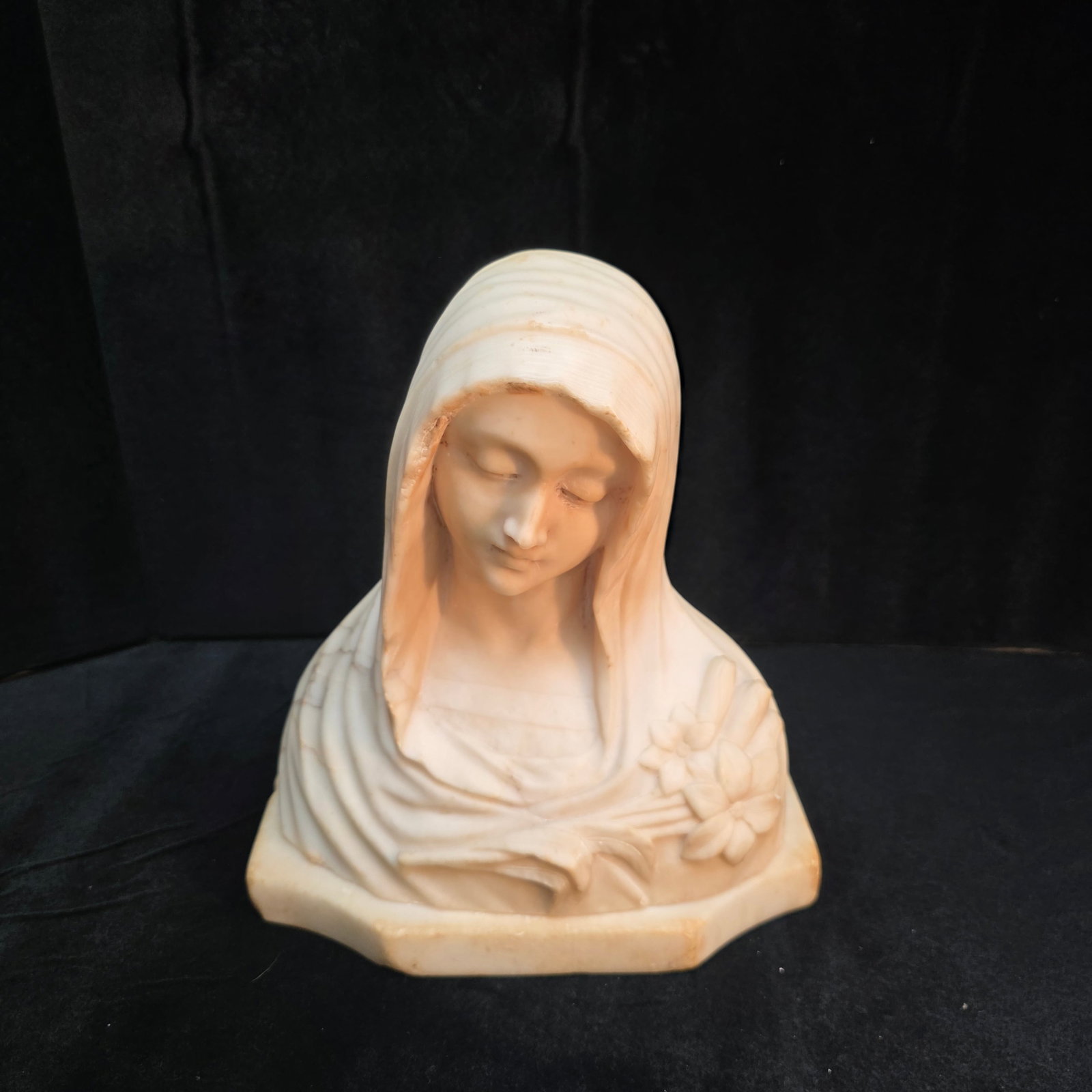 Italian Alabaster Bust of The Virgin Mary: Lilies adorn her left shoulder.
