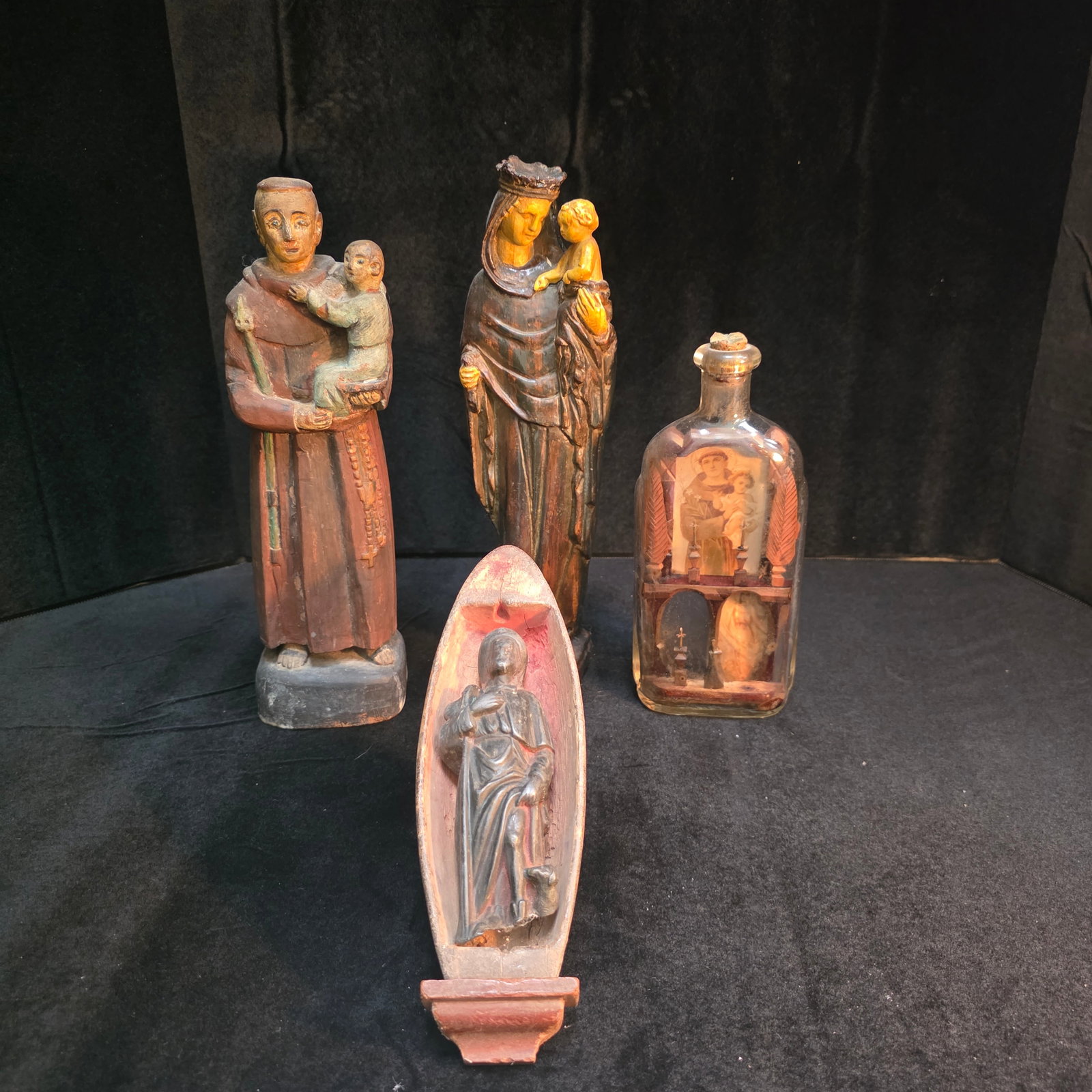 Lot of Rustic Catholic Figures: Madonna & child 12x3.5x2" deep broken corner. Saint Roch in the boat 9x3x2" metal and wood-broken foot .Whimsy bottle 9x4x2"Folkart St Anthony All carved wood 12x4x4"-paint chip on head