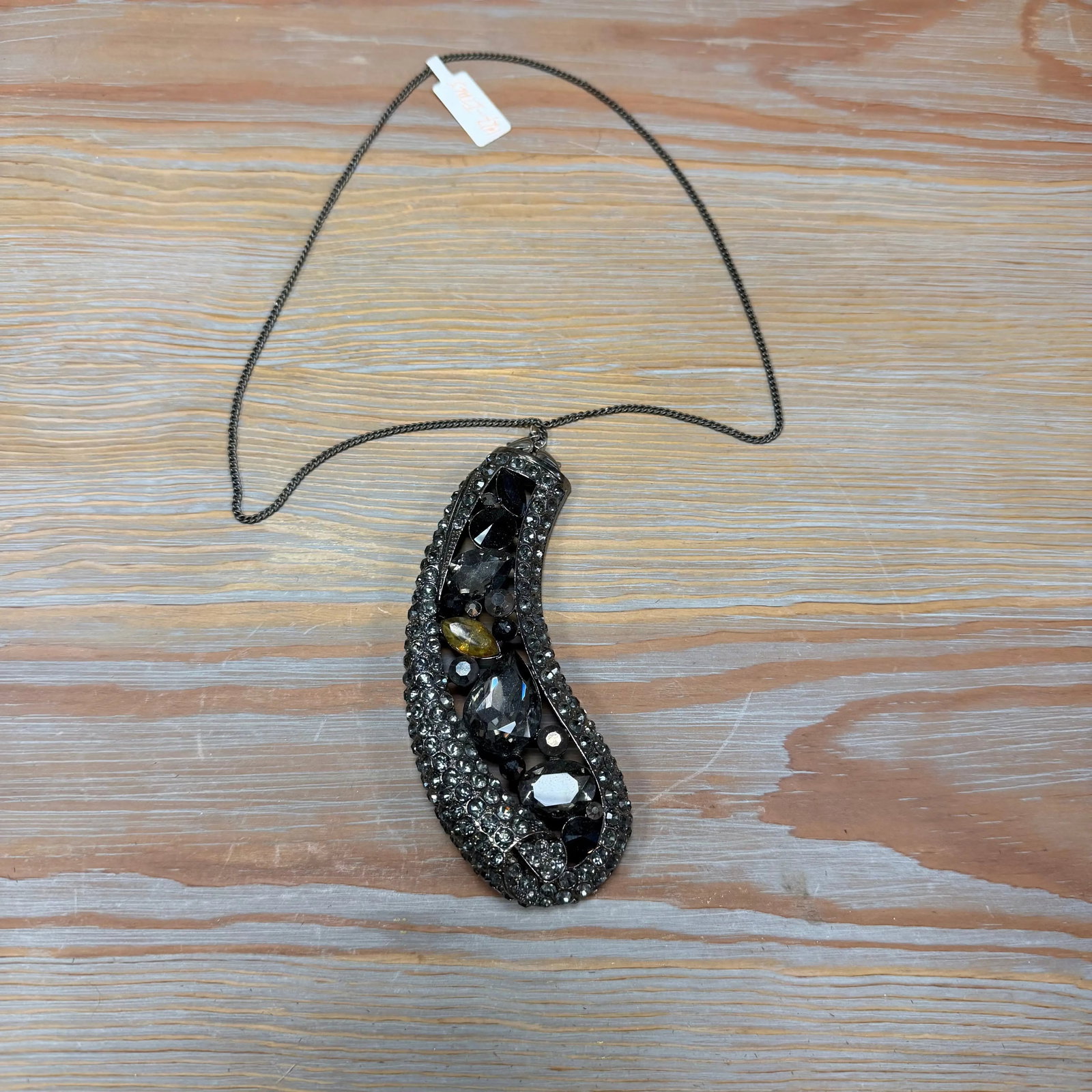 Hematite-Tone Pendant 3" Pendant, HD39: Curved vertical pendant with metallic beadwork on a black cord.