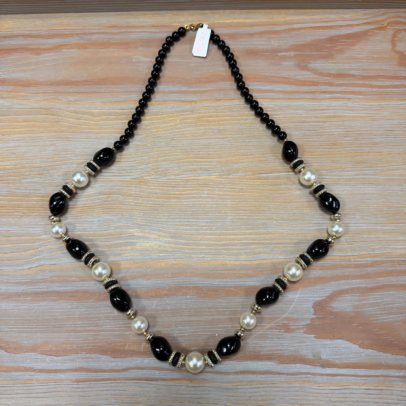 Classic Pearl & Jet Bead Strand 24" Length, HD42: Alternating faux pearls and black beads with gold-tone spacers.