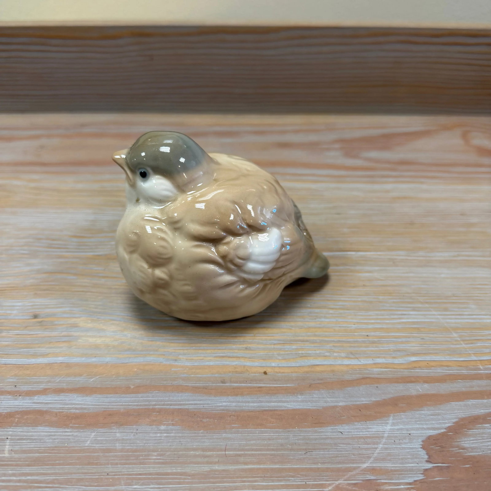 Porcelain Songbird Figurine 2.5" H x 3.5" L, HD48: High-gloss ceramic bird in fawn and grey with white accents.