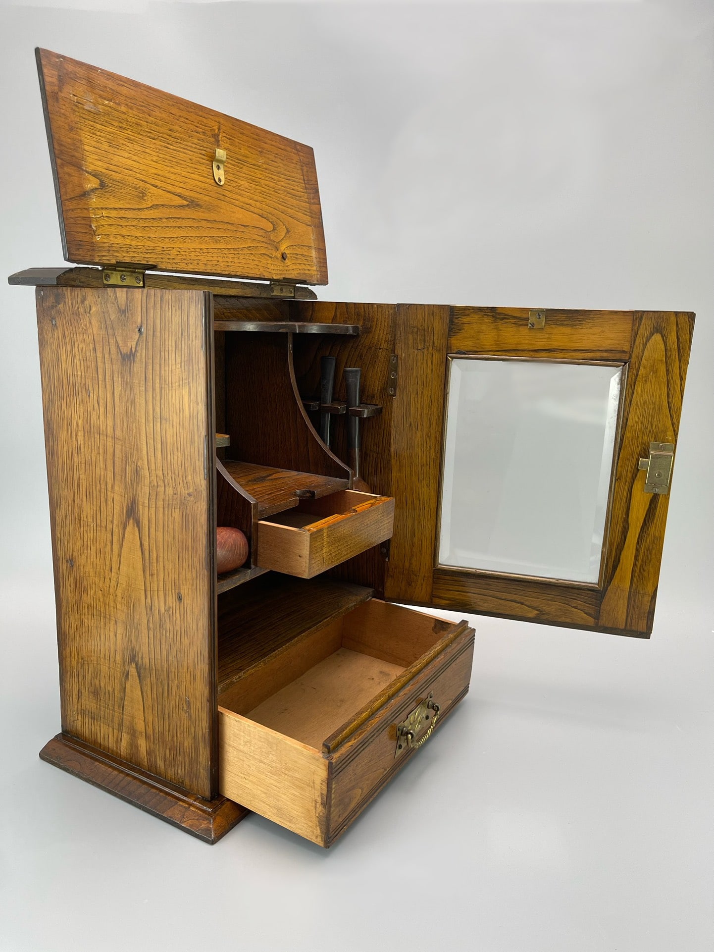 A SOLID OAK PIPE CABINET, 1925 - 6