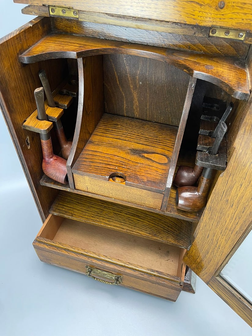 A SOLID OAK PIPE CABINET, 1925 - 9