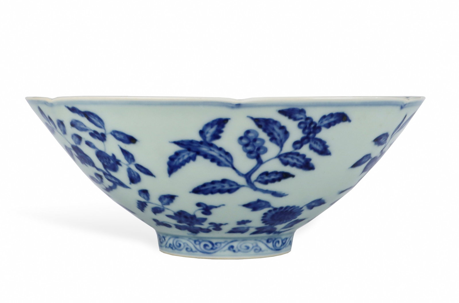 A BLUE AND WHITE 'BRANCHING FRUITS AND FLOWERS' LOBED BOWL: A BLUE AND WHITE 'BRANCHING FRUITS AND FLOWERS' LOBED BOWL Height: 8.2 cm (3.2 in.), Width: 21.5 cm (8.5 in.). All measurements are approximate.