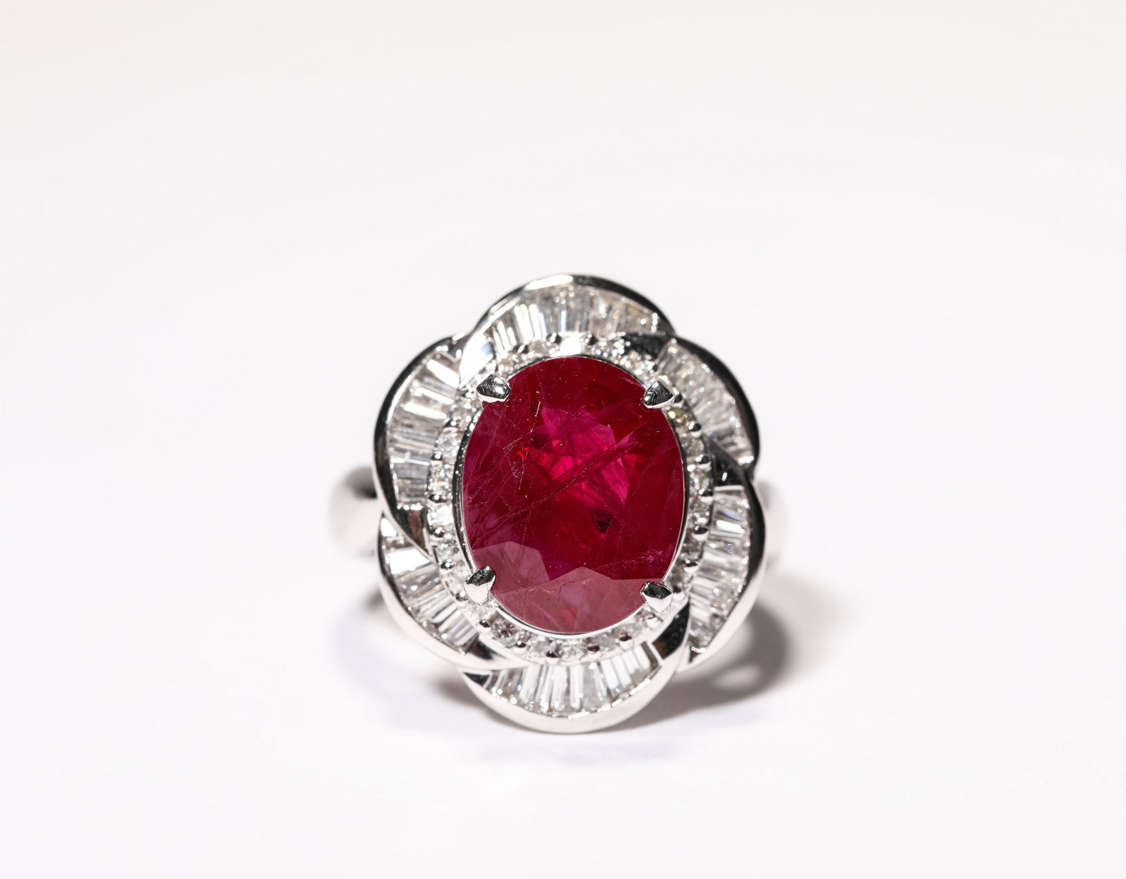 A GOLD RUBY AND DIAMOND RING: A GOLD RUBY AND DIAMOND RING Weight: 13 g, Ring Size: 1.7 cm (0.7 in.), Width: 1.7 cm (0.7 in.), Height: 2 cm (0.8 in.). All measurements are approximate.