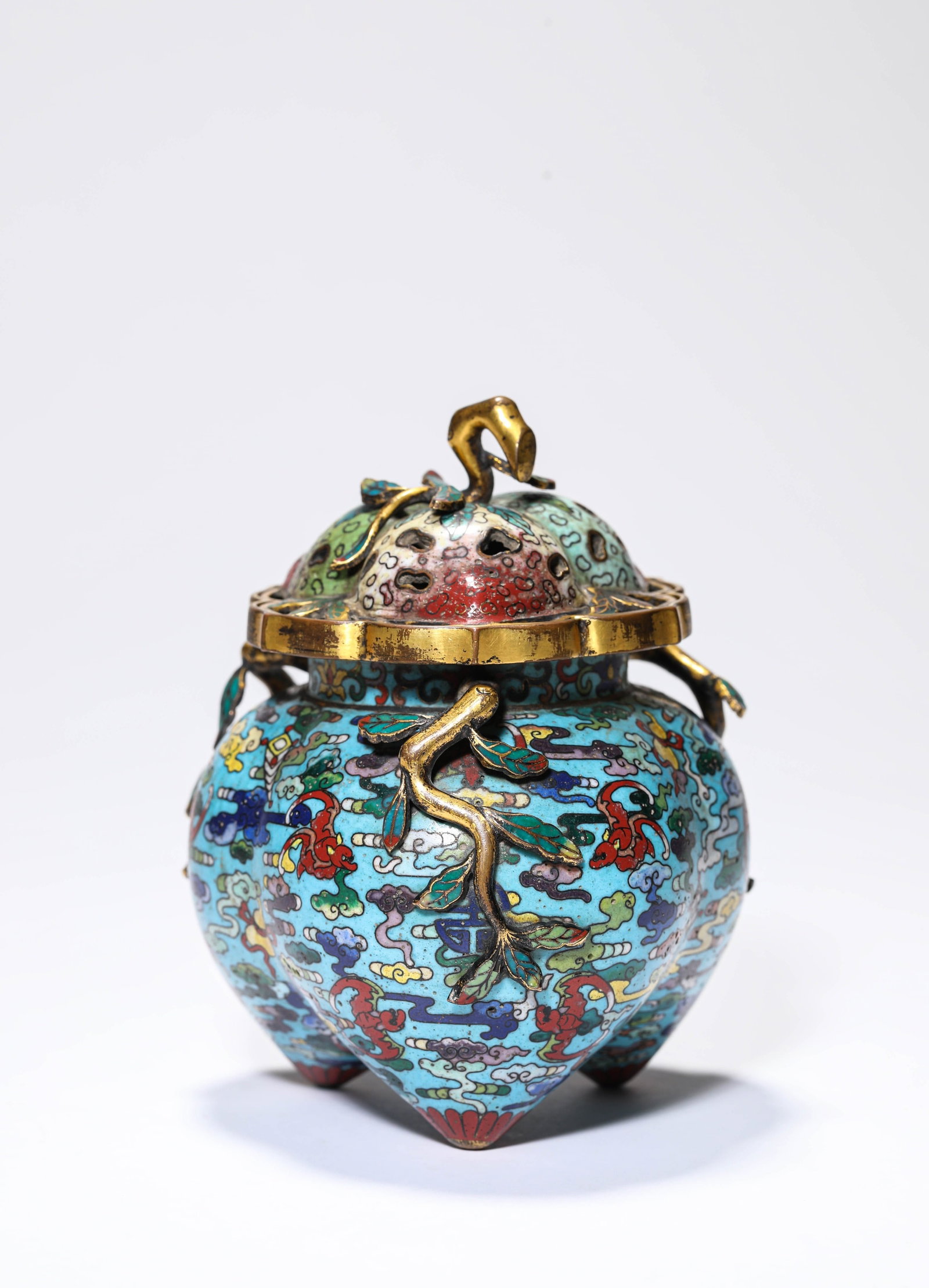 A COPPER-BODY CLOISONNé 'PEACH OF LONGEVITY' THREE-LEGGED CENSER: A COPPER-BODY CLOISONNé 'PEACH OF LONGEVITY' THREE-LEGGED CENSER Weight: 709 g, Width: 11.2 cm (4.4 in.), Height: 14.2 cm (5.6 in.). All measurements are approximate.