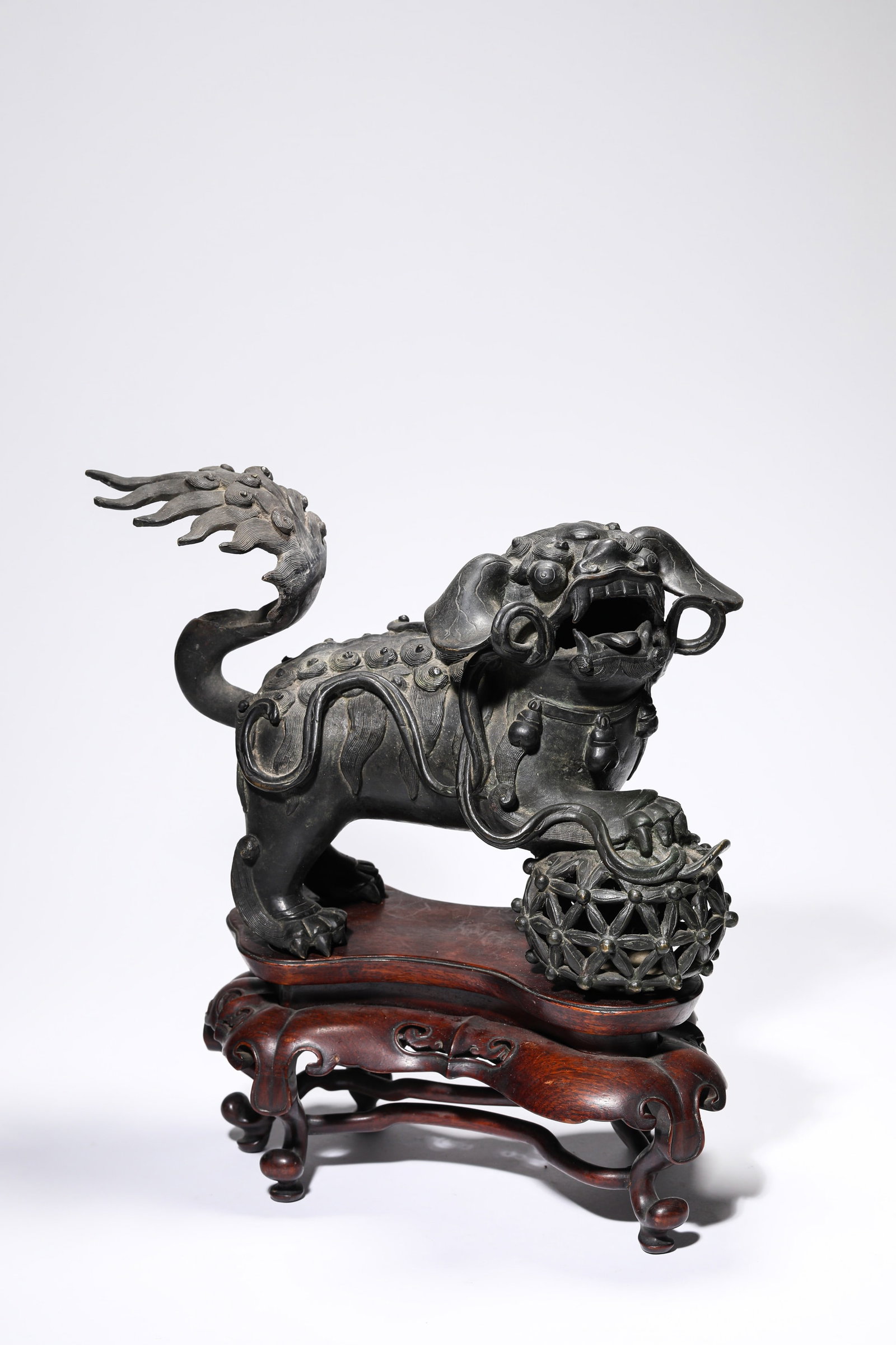 A BRONZE 'LION PLAYING WITH EMBROIDERED BALL' ORNAMENT (1 of 8)