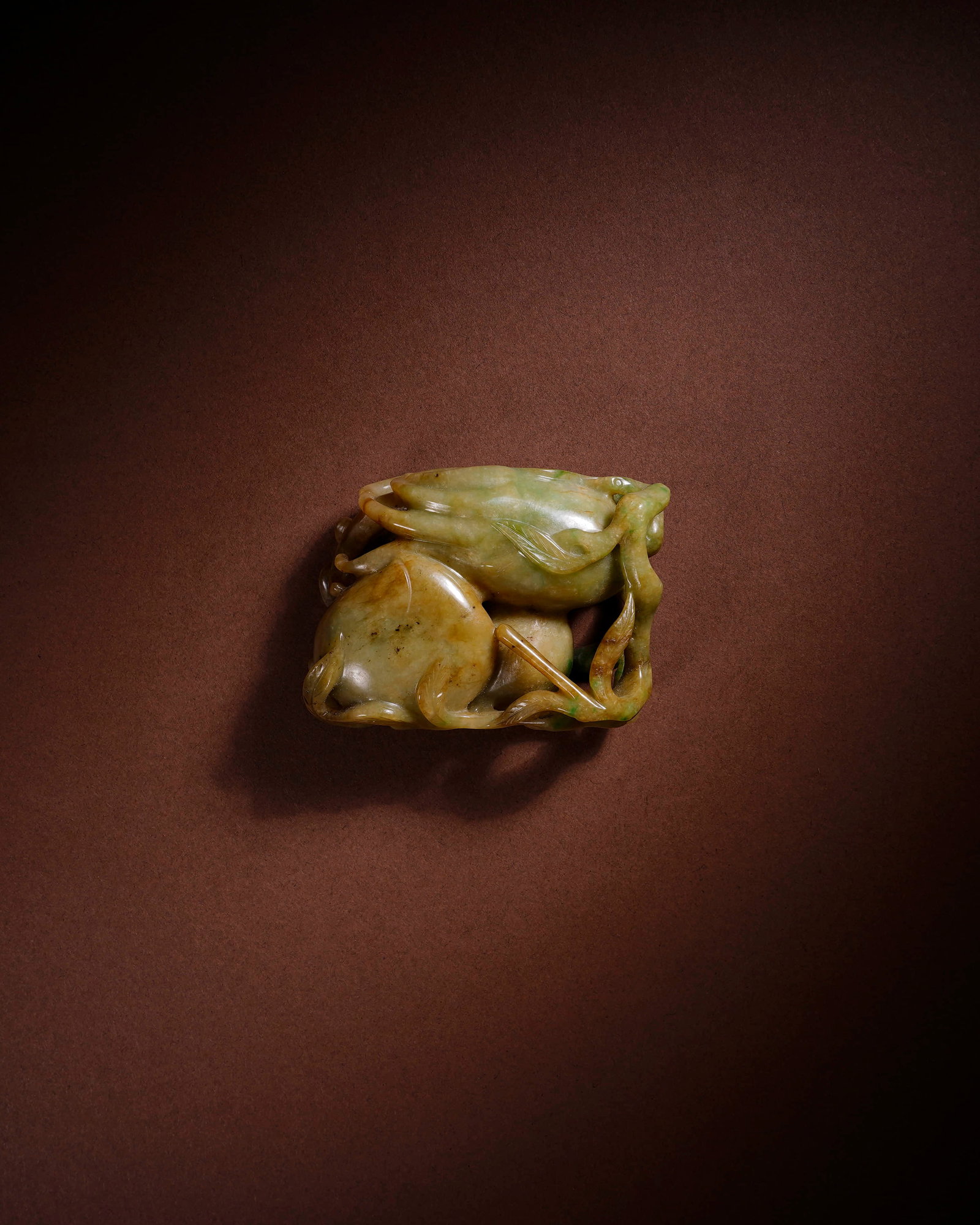 A JADEITE 'DOUBLE BAT AND SHOU' HANDPIECE: A JADEITE 'DOUBLE BAT AND SHOU' HANDPIECE Length: 4.8 cm (1.9 in.), Height: 6.3 cm (2.5 in.). All measurements are approximate.