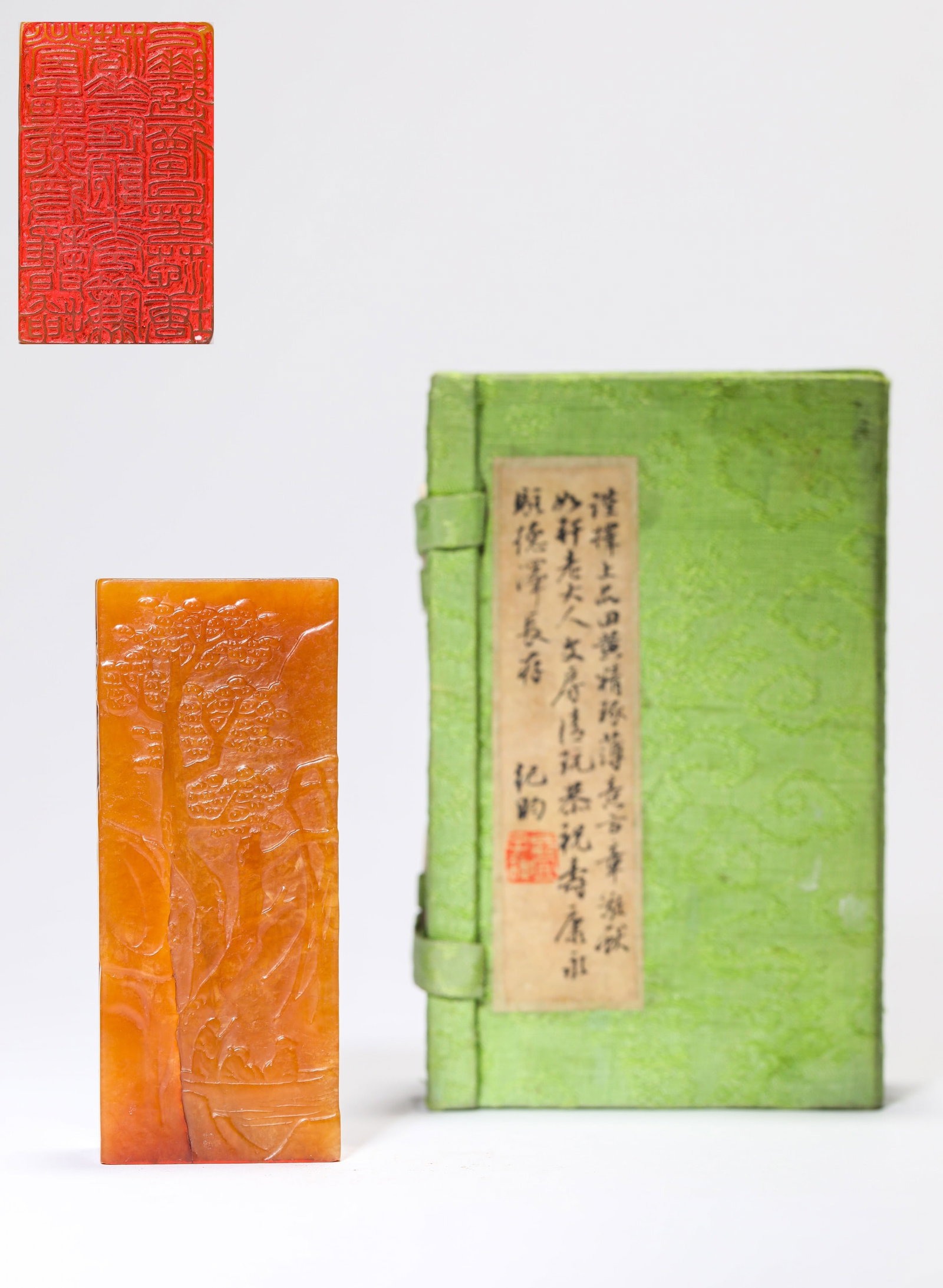 A CARVED TIANHUANG STONE 'FIGURE STORY' SEAL: A CARVED TIANHUANG STONE 'FIGURE STORY' SEAL Length: 3.5 cm (1.4 in.), Width: 2.1 cm (0.8 in.), Height: 8.4 cm (3.3 in.). All measurements are approximate.