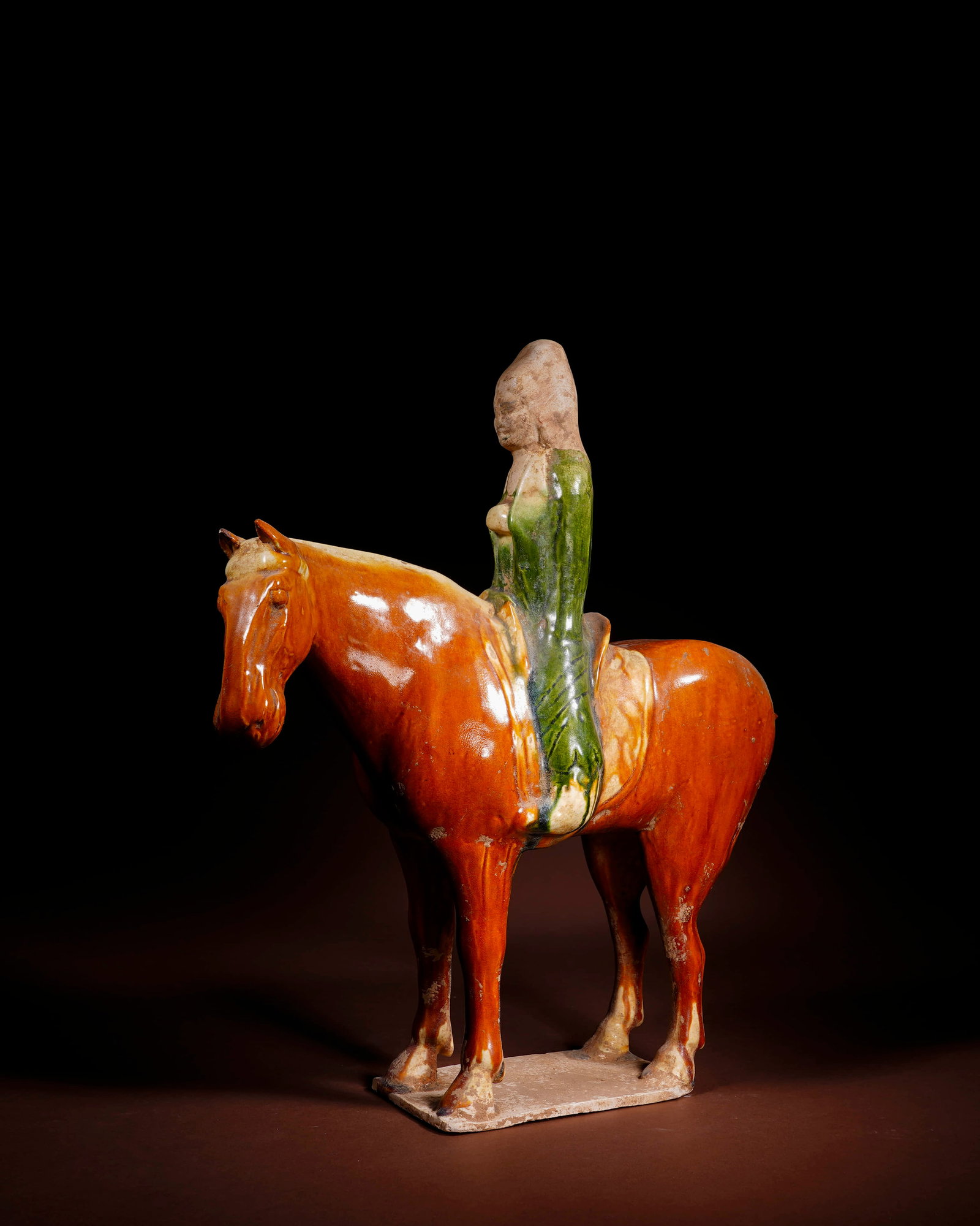 A SANCAI-GLAZED POTTERY 'HORSE AND RIDER' FIGURINE: A SANCAI-GLAZED POTTERY 'HORSE AND RIDER' FIGURINE Length: 30.5 cm (12.0 in.), Height: 36 cm (14.2 in.). All measurements are approximate.