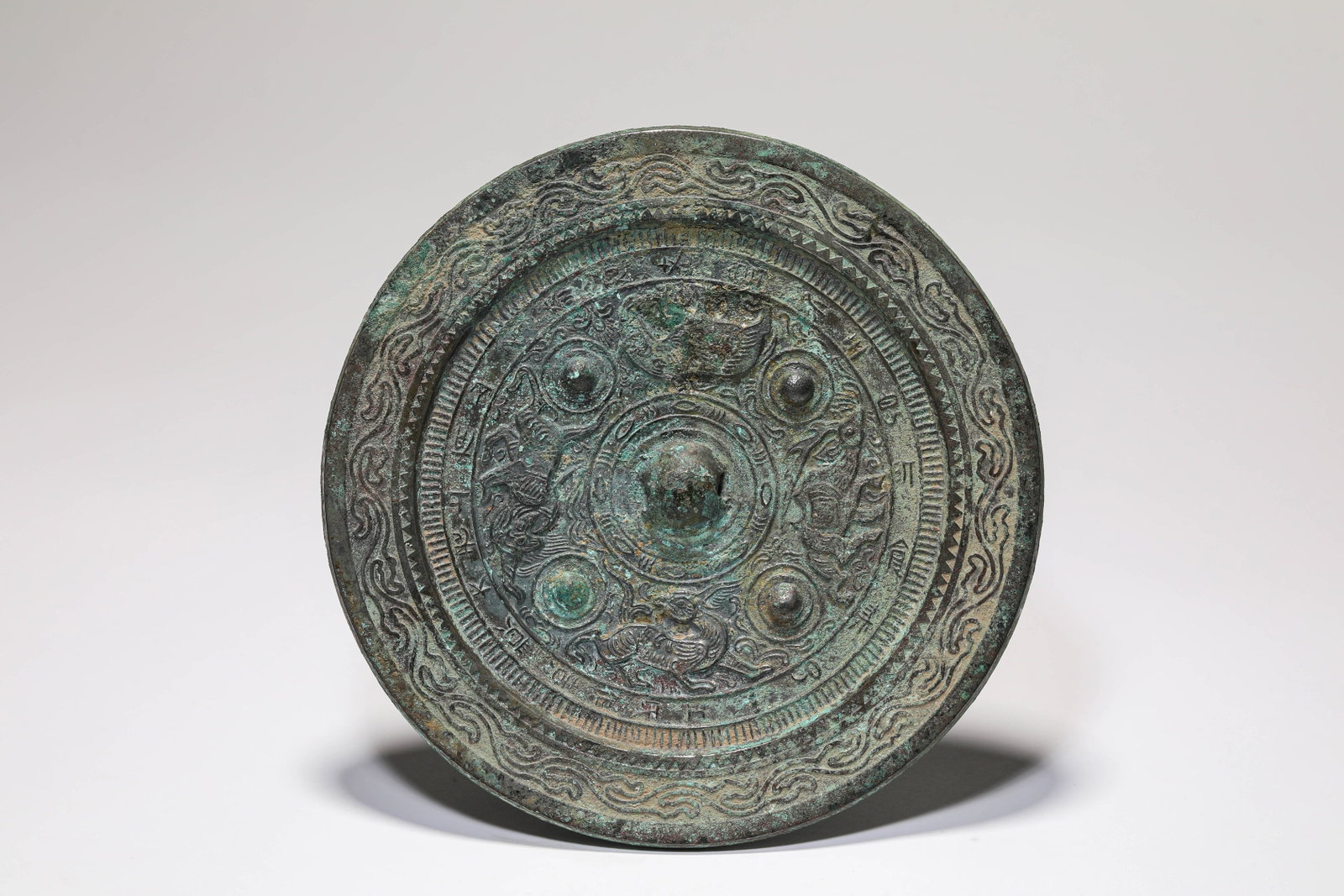A BRONZE 'AUSPICIOUS BEAST' MIRROR (1 of 7)