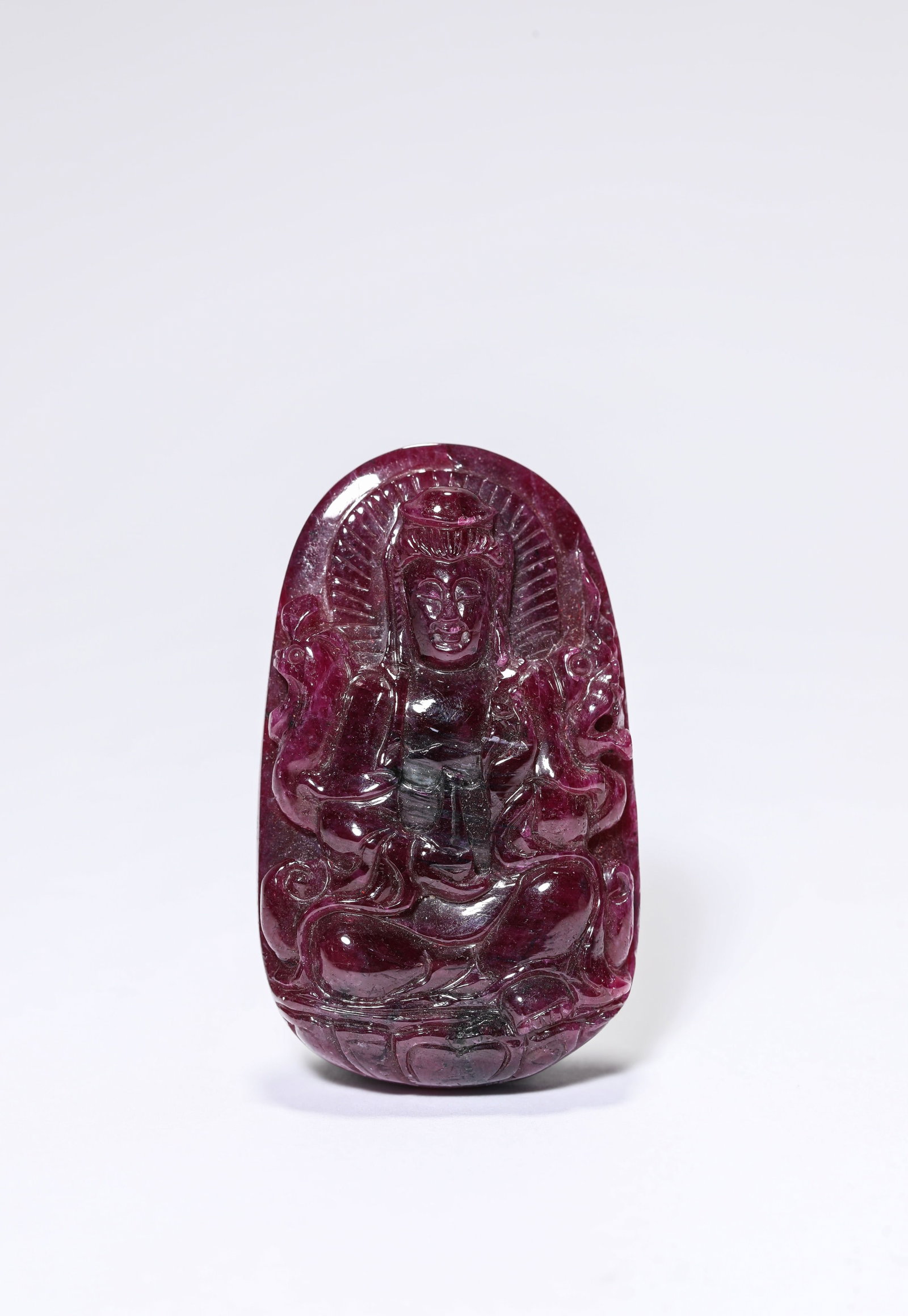 A CARVED TOURMALINE GUANYIN FIGURE: A CARVED TOURMALINE GUANYIN FIGURE Width: 3.2 cm (1.3 in.), Height: 5.3 cm (2.1 in.). All measurements are approximate.