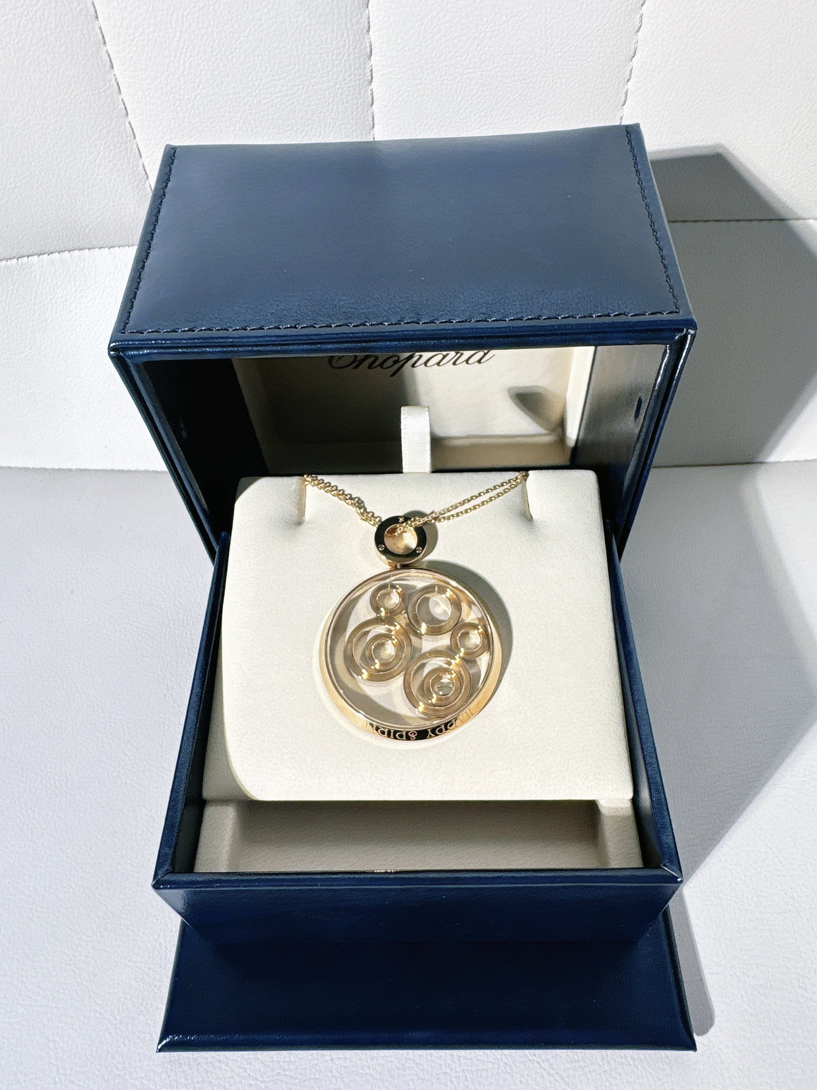 Signed Chopard 18K White Gold Happy Spirit Large Floating Diamond Pendant: Chopard Happy Spirit Large Pendant in 18K white goldKey FeaturesDesign: Part of the iconic Happy Spirit collection, this piece features several concentric white gold "dancing" hoops of varying sizesTh