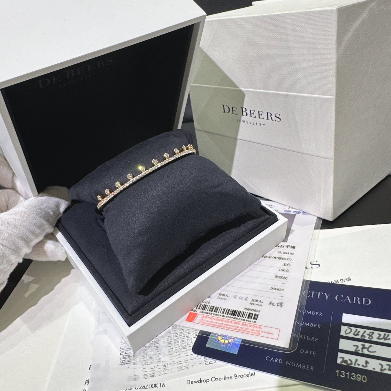 De Beers Natural Diamond 18k Rose Gold Dewdrop Bangle Size 16: The design is a modern interpretation of the iconic Dewdrop motif, featuring a row of micropave diamonds accented by larger, bezel-set diamonds meant to resemble glistening dewdrops.Key FeaturesDesign