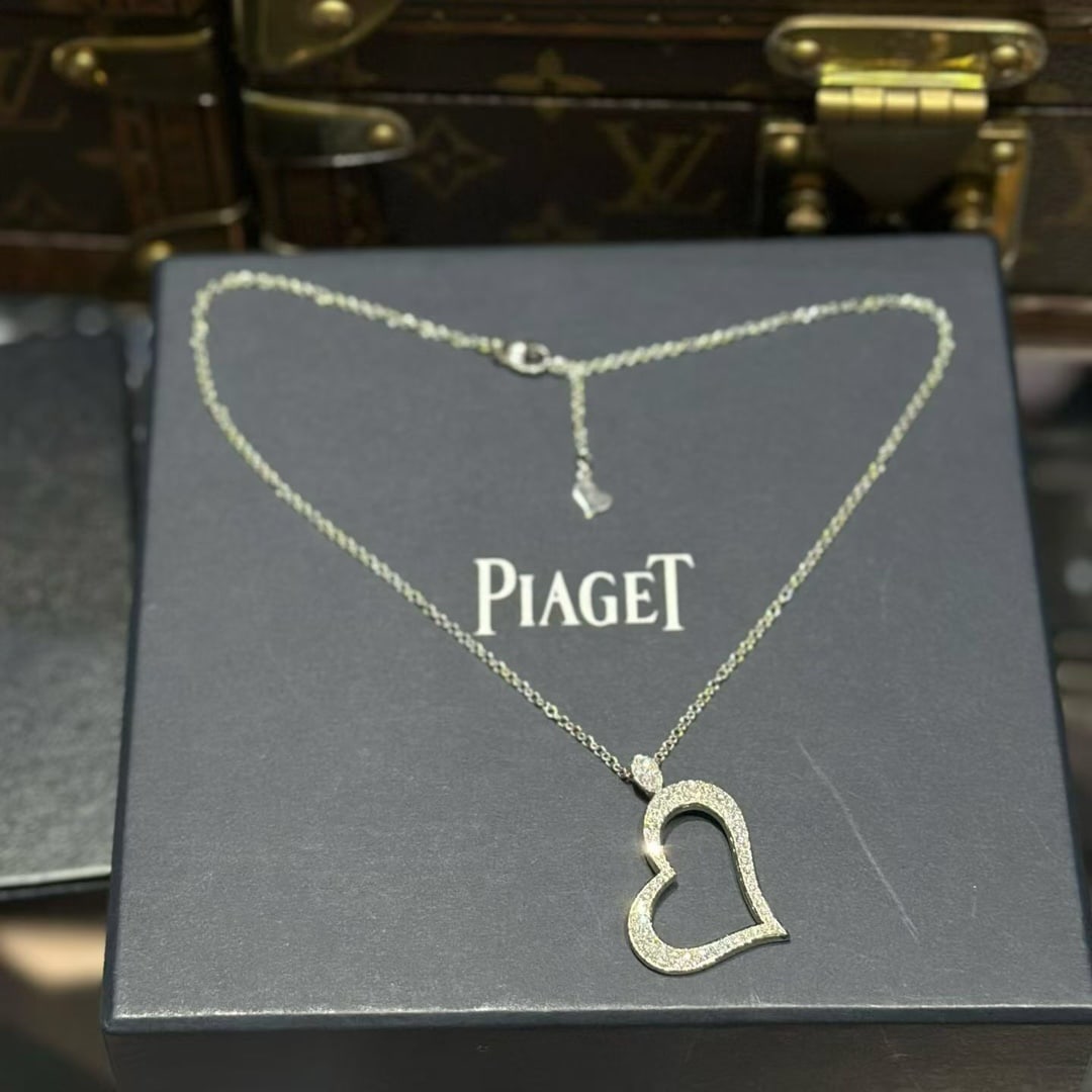 Piaget Limelight Geart Diamond Necklace 18k White Gold: This heart-shaped pendant is a piece from the Piaget Limelight jewelry collection. Crafted in 18k white gold, the stylized open heart is pave-set with round brilliant-cut diamonds.Product DetailsBrand