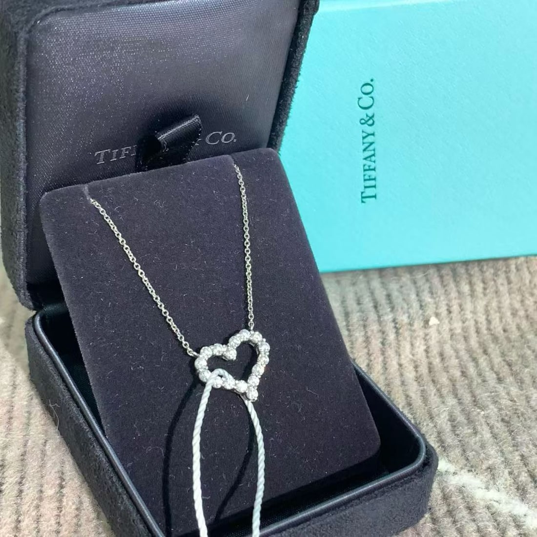 Tiffany & Co Diamond Open Heart Pendant Necklace Medium 18K White Gold: Tiffany Hearts Pendant: Set in platinum with round brilliant diamonds."Loving Heart" Collection: A popular variation by designer Paloma Picasso for Tiffany & Co..