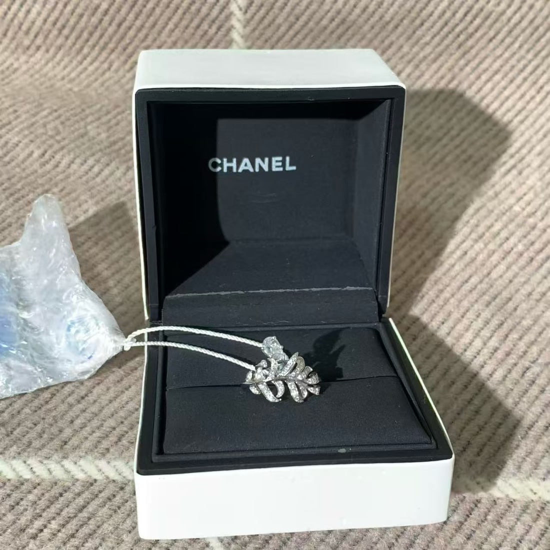 Chanel Plume de Chanel Ring, 18K White Gold, 0.55ct Pear Diamond: Material: The ring is crafted from 18K white gold.Gemstones: It features multiple diamonds, including a central pear-shaped diamond.