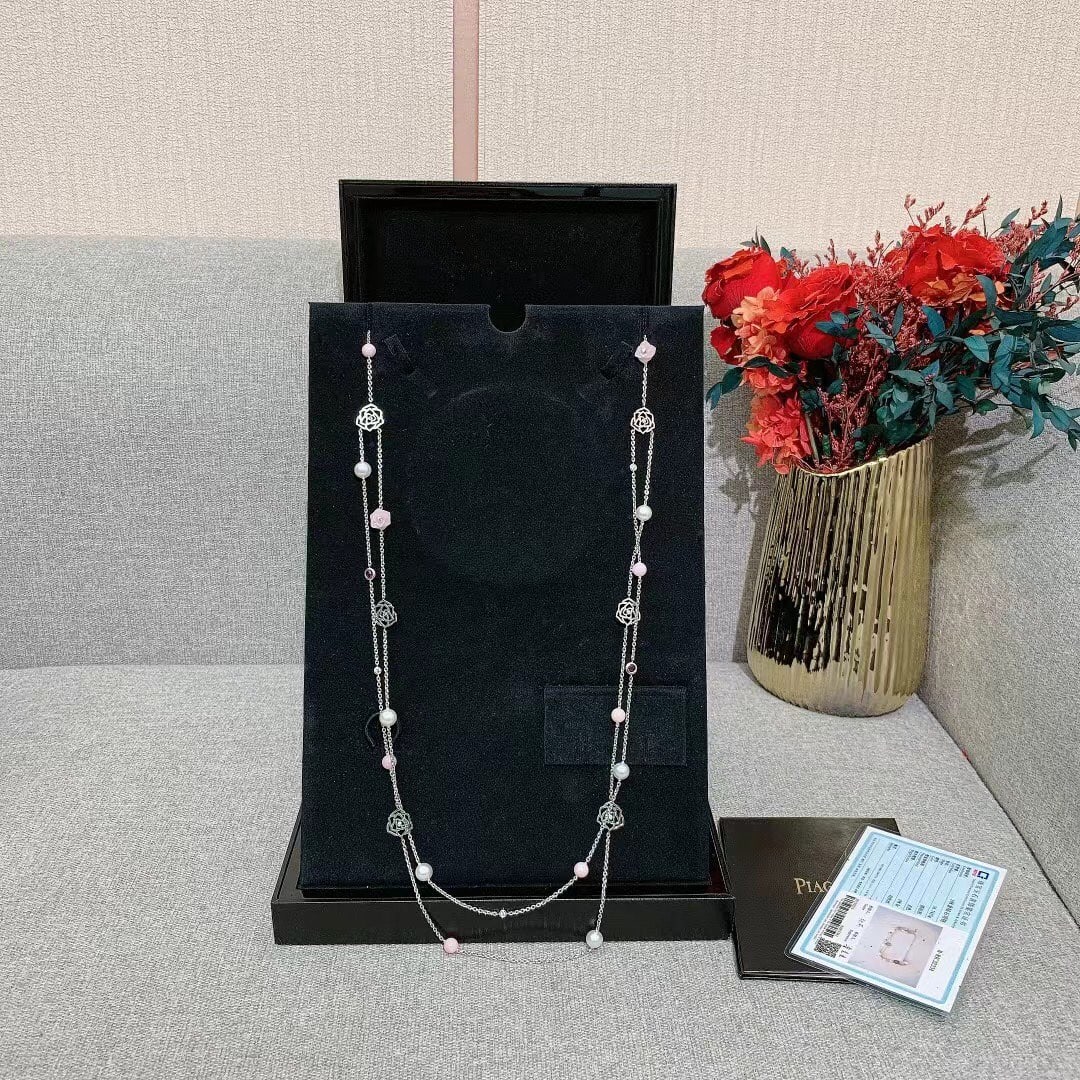 Piaget Rose Pink Opal Pink Tourmaline Pearls Diamonds 18K Gold Necklace: This necklace is part of the Piaget Rose collection, a line of fine jewelry that pays tribute to Yves Piaget's favorite flower. This specific piece is an 18K white gold long "sautoir" style necklace f