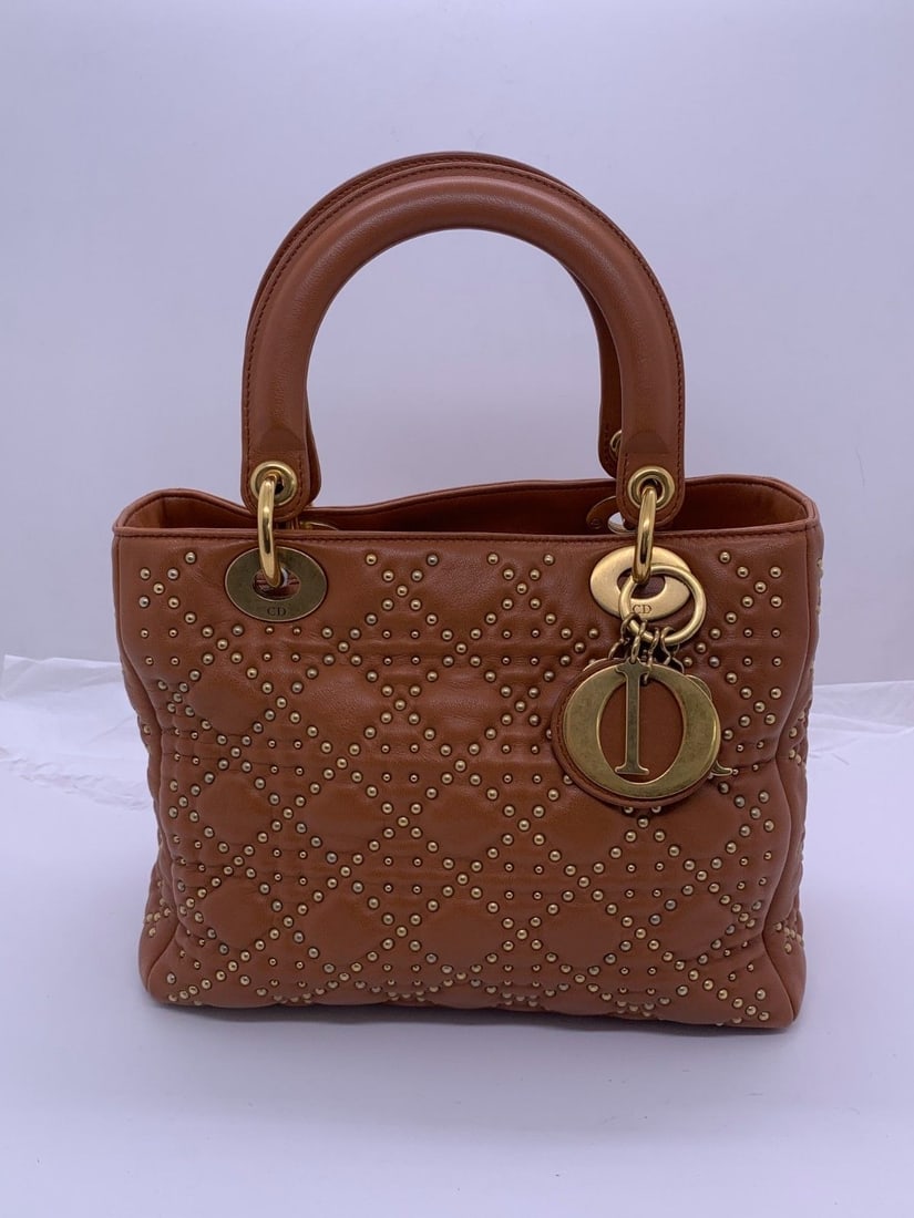 Christian Dior Lady Dior Bag Studded Brown Lambskin Leather Origin Italy: Normal signs of use, worn corners, scratched and faded metal fittings, minor stains on the leather, and clean interior.Worn handle