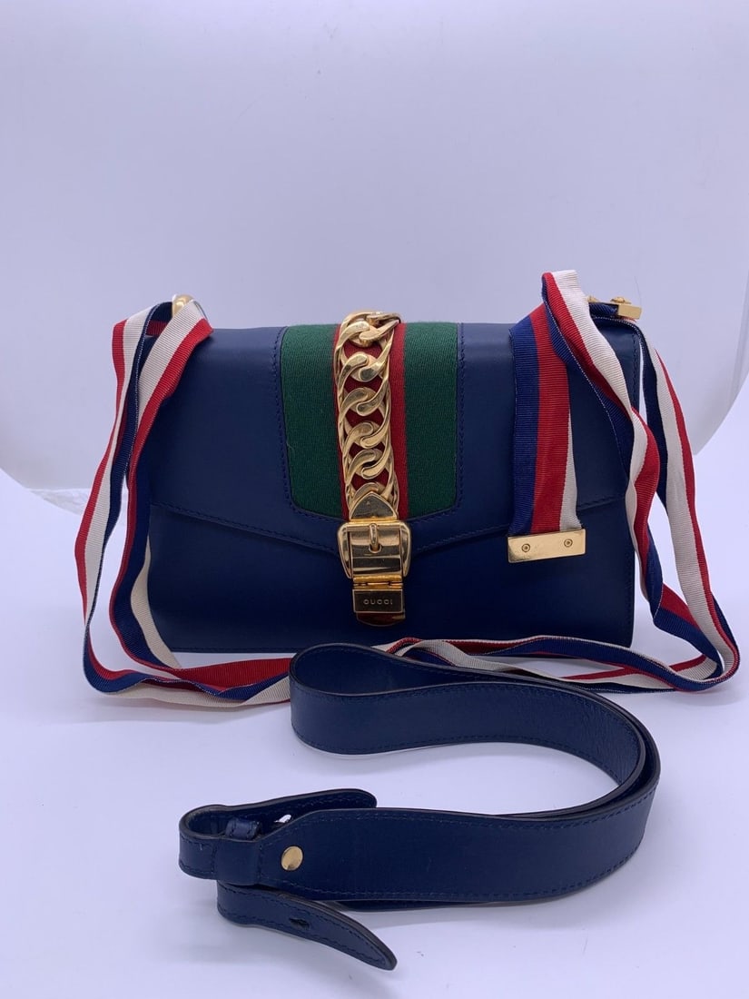 Auth Gucci Sylvie Blue Leather Shoulder Bag Origin Italy: Signs of normal use with worn corners. The hardware has scratches and scuffs, the leather on the handle shows minor damage and stains, while the interior is clean