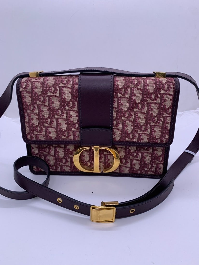Christian Dior 30 Montaigne Burgundy Oblique Jacquard Canvas Bag Italy: It shows normal signs of use, with slight scuffs on the four corners, scratches on the hardware and a clean interior. Two leather sleeves on the shoulder strap are missing.