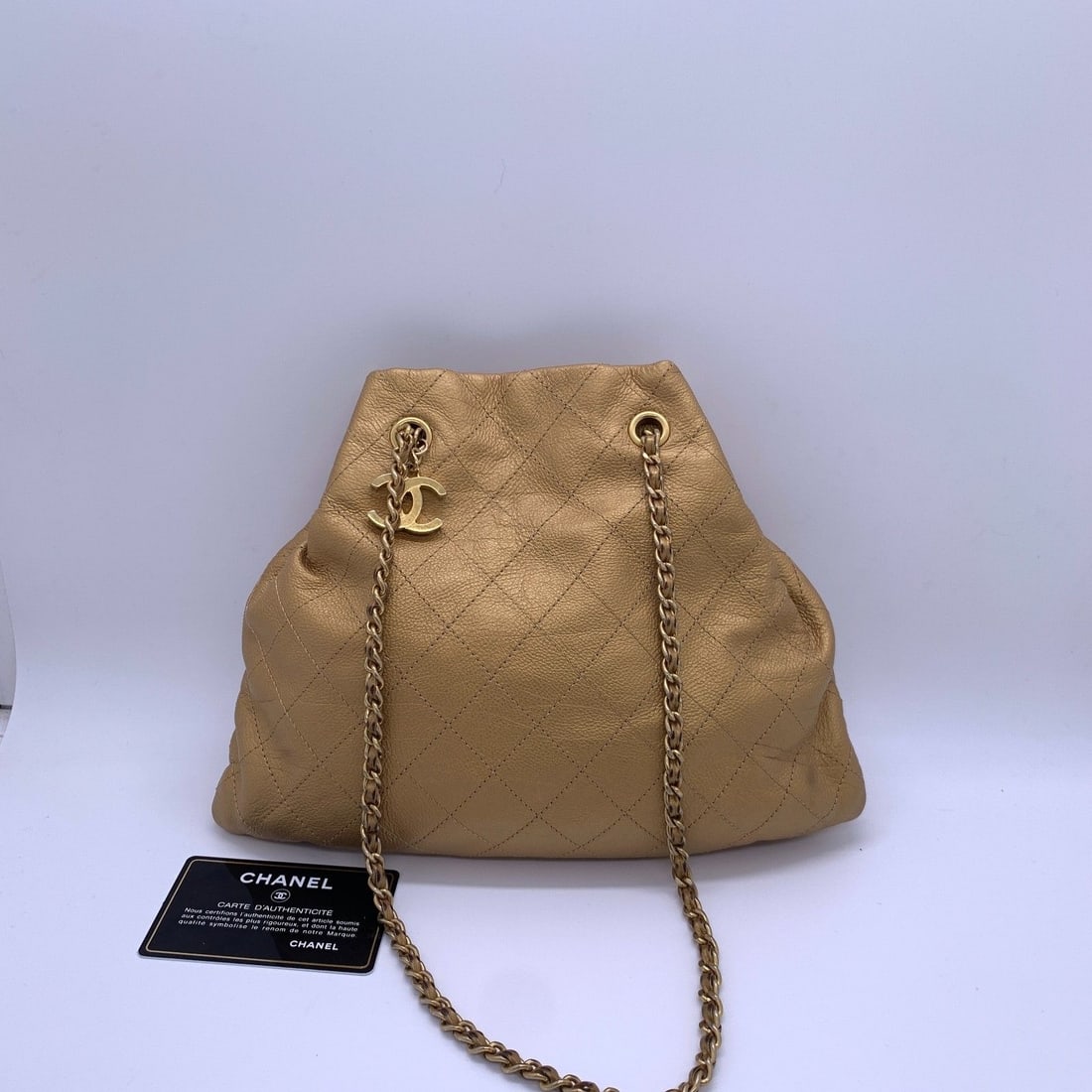 CHANEL Metallic Gold Quilted Calfskin Drawstring Bucket Bag Mini: Condition: Normal signs of wear, corner wear, scratches on hardware, chain abrasion.Accessories: ID cardsize: Width:29cm,height:23cm