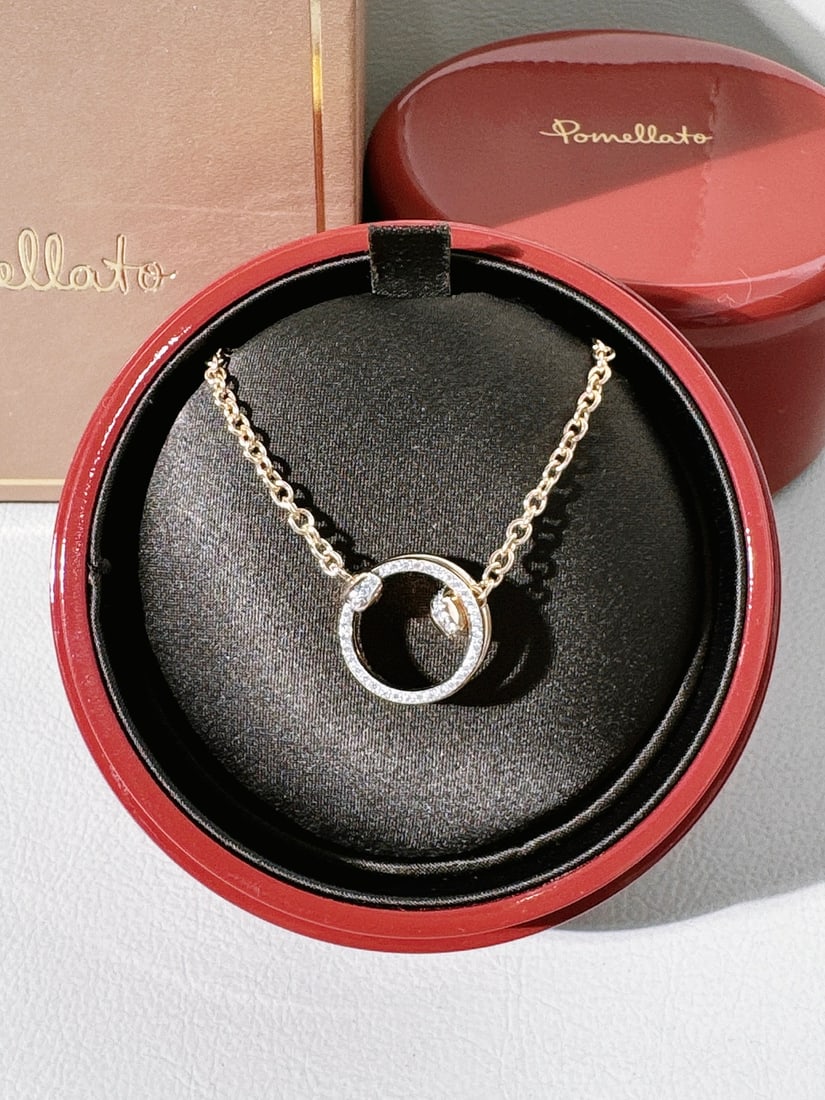 Pomellato Together Necklace 18K Rose Gold Pave Diamonds: Pomellato Together collection. It features a pendant with two interlocking bands, designed to symbolize the bonds and connections that unite us.The specific model shown typically consists of:Material: