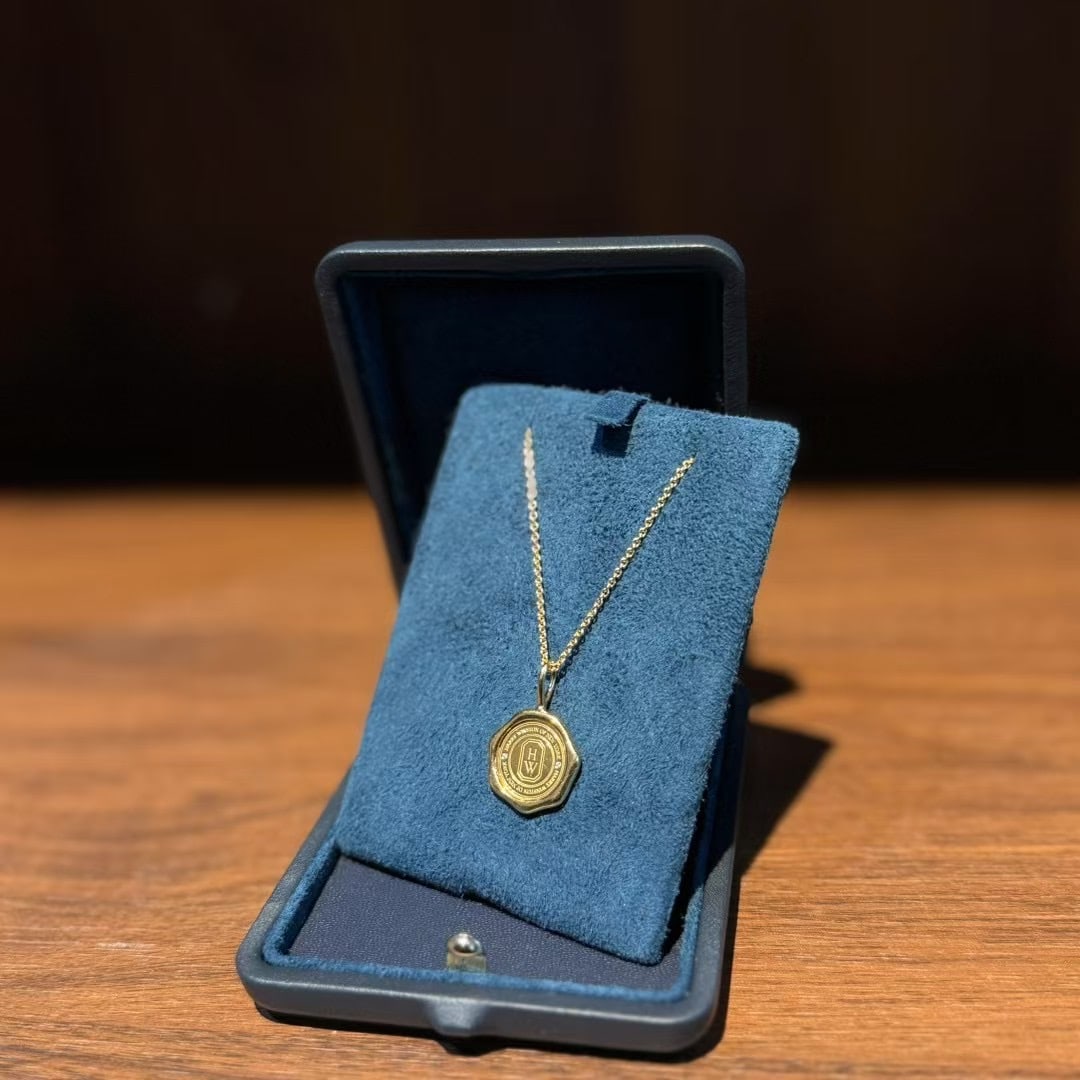 Harry Winston Diamond Charm Pendant Necklace: Charms by Harry Winston "Shield" Pendant, a piece from the brand's iconic Charms collection.The design is inspired by the official seal used by the house, which features the founder's initials, "H" an