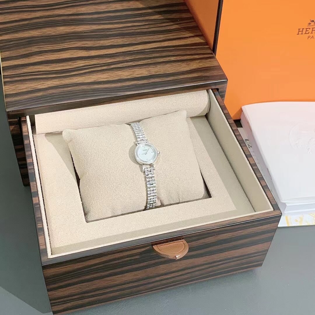 Hermes Faubourg Watch Pave-set diamonds 18K White Gold mother-of-pearl dial: Mini modelDiamond-set white gold case, 15 mm diameter, 44 diamonds (0.128 ct)Anti-glare sapphire crystal and case-backDiamond-set mother-of-pearl dial, 4 diamonds (0.006 ct)Quartz movement, Swiss Made