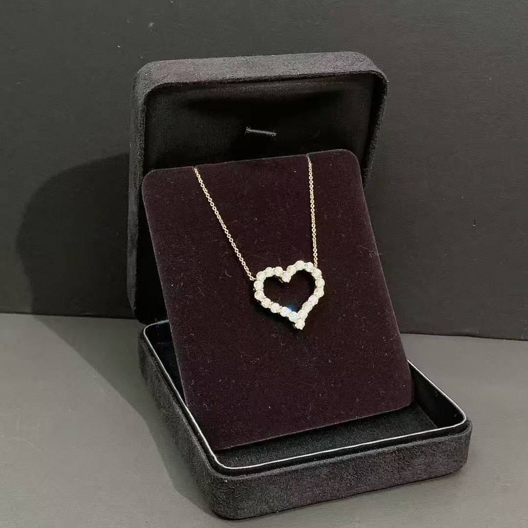 Tiffany & Co. Diamond 18K Yellow Gold Heart Pendant Necklace L Size: Tiffany & Co. Sentimental Heart NecklaceThis classic design is available in various sizes and metal types from multiple high-end and luxury retailers.Design and SpecificationsStyle: An open-frame hear